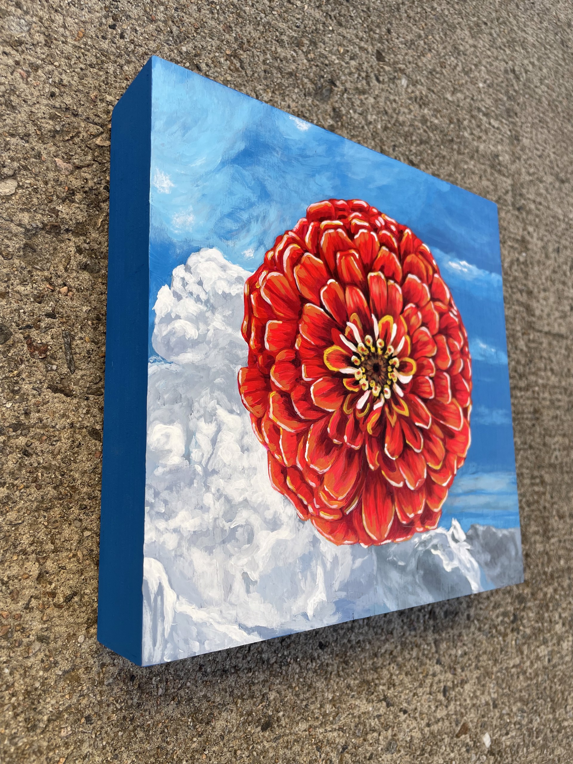 A painting of a red flower on a blue background.
