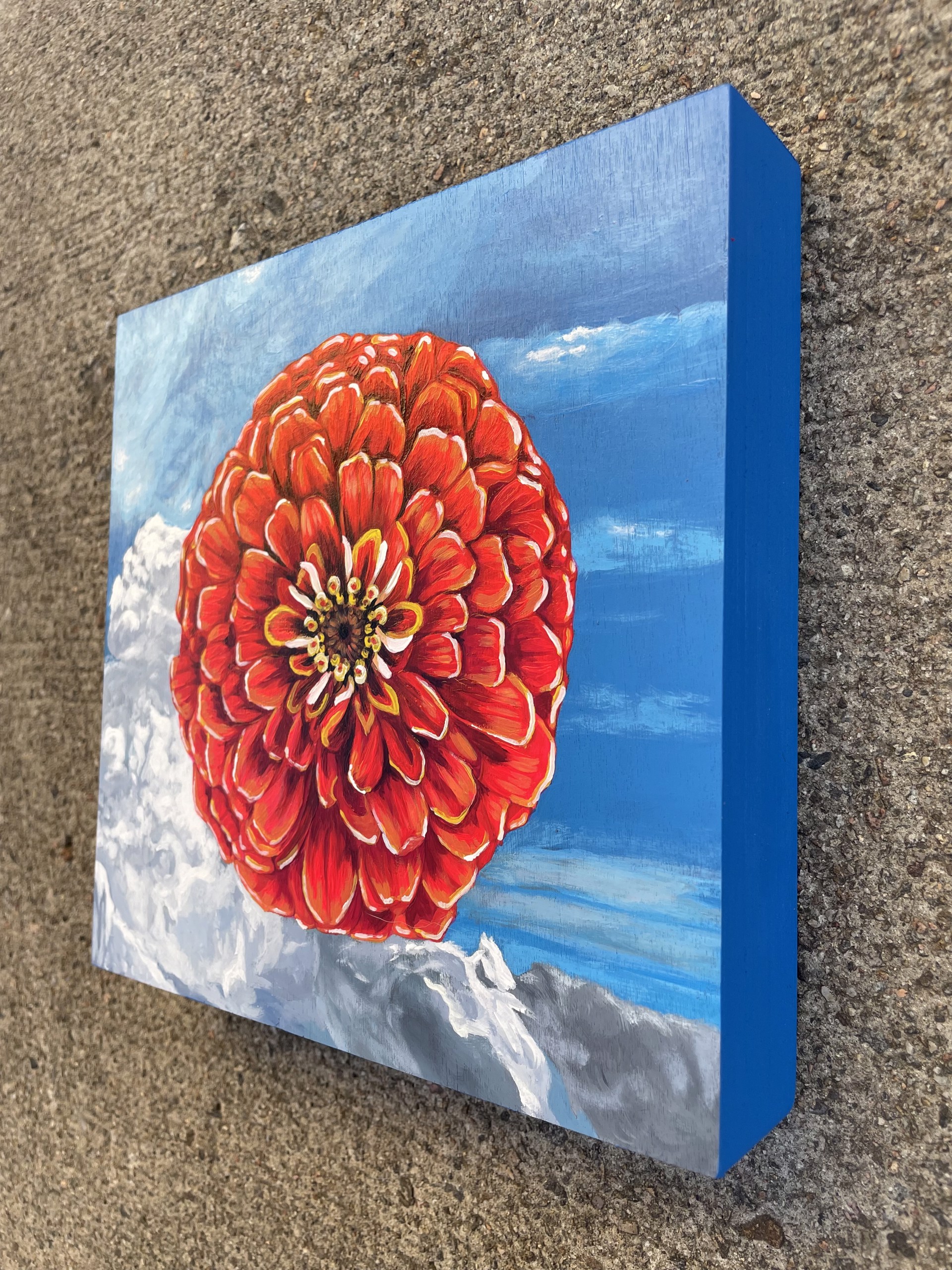 A painting of a red flower on a blue background.