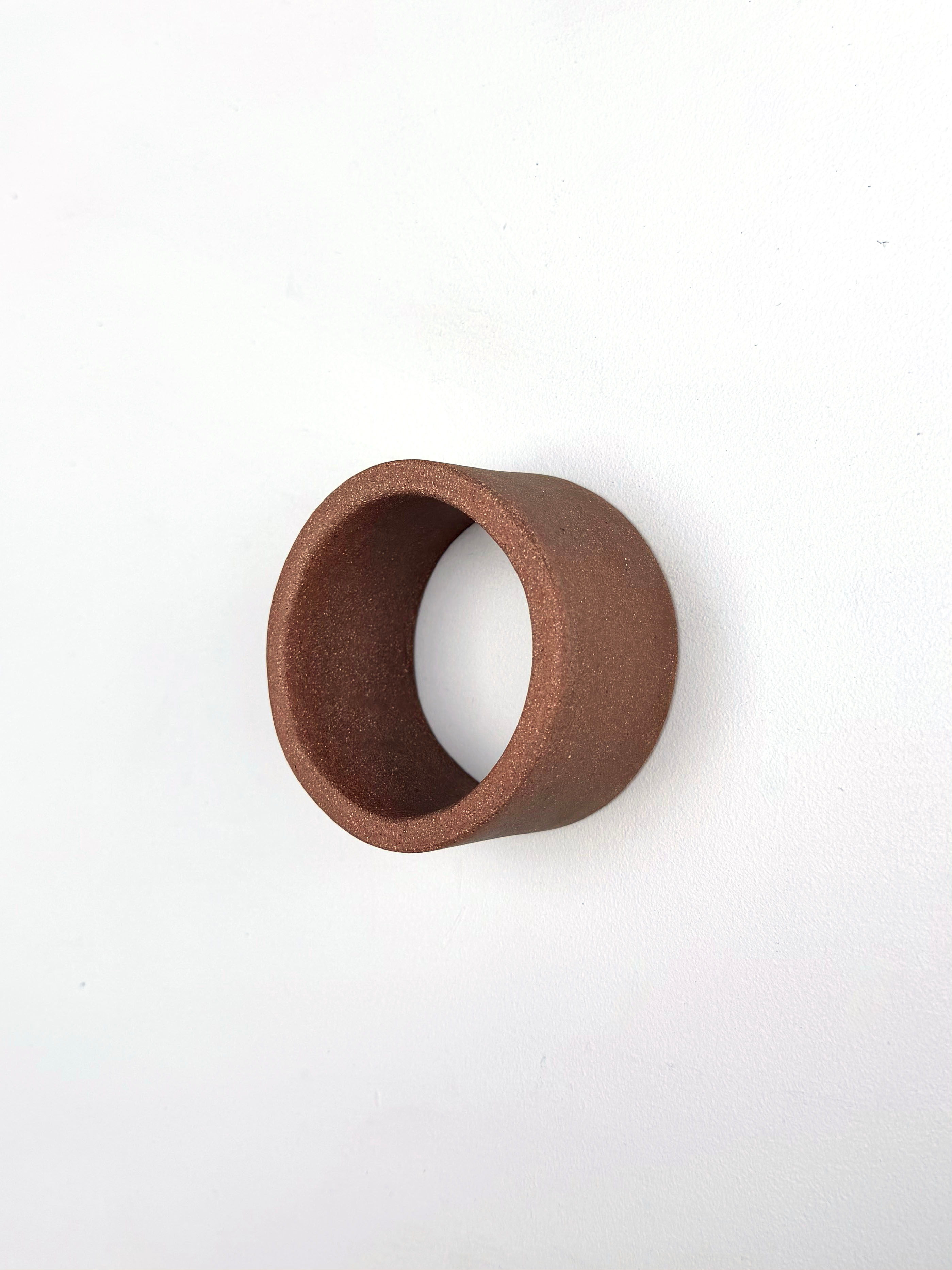 A brown ring on a white surface. 