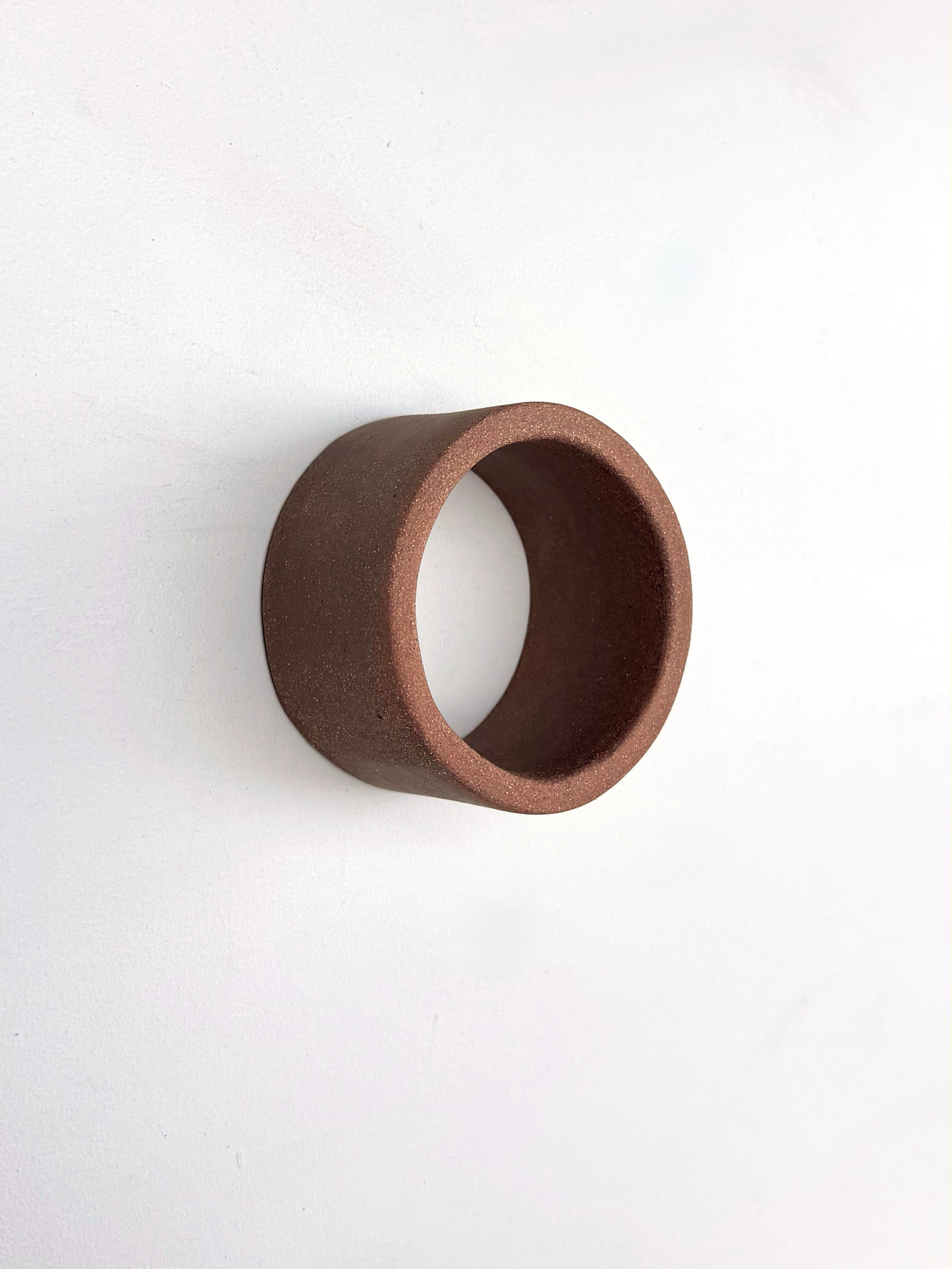 A brown ring on a white surface. 