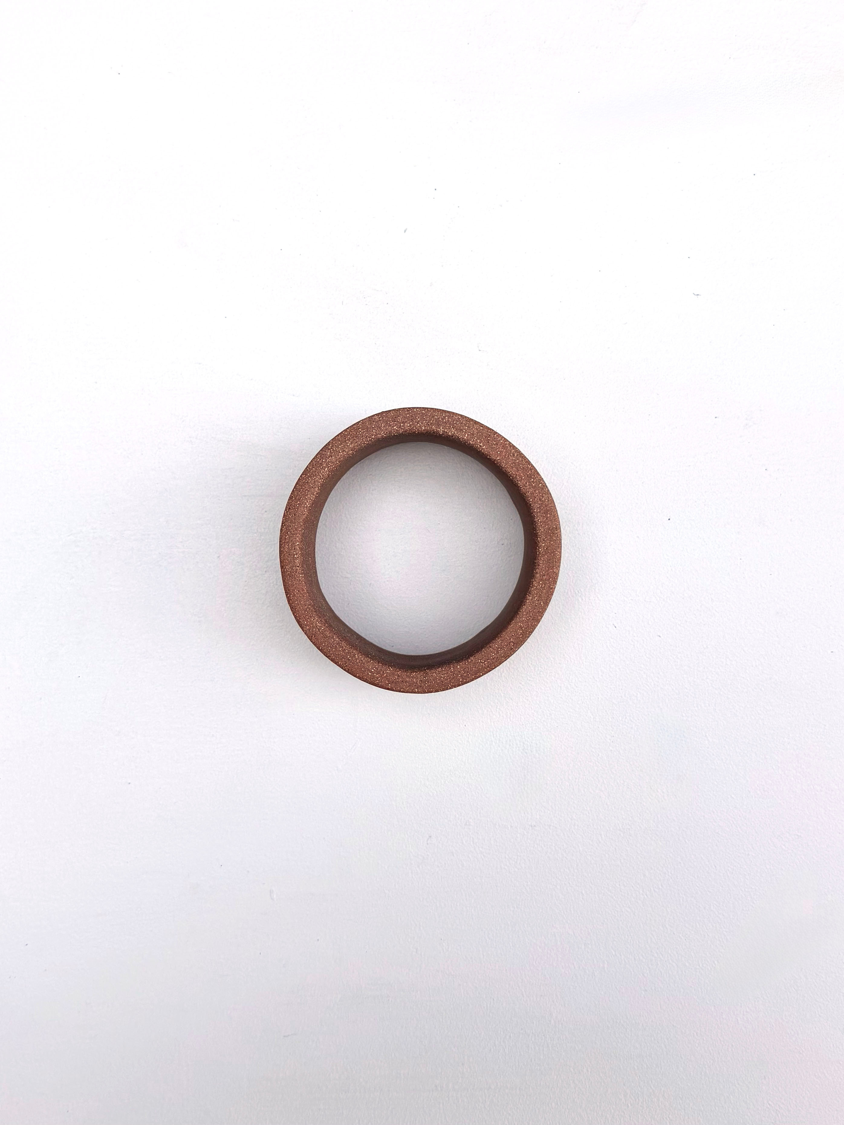 A brown ring on a white surface. 