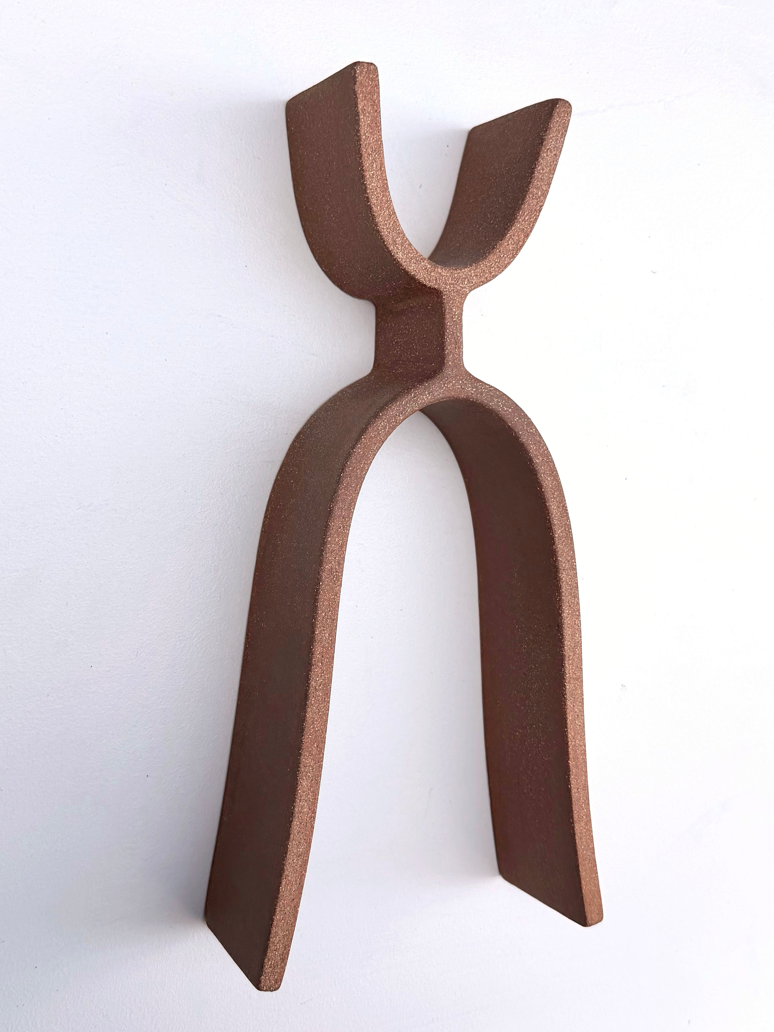 A pair of tongs that are sitting on a white surface.