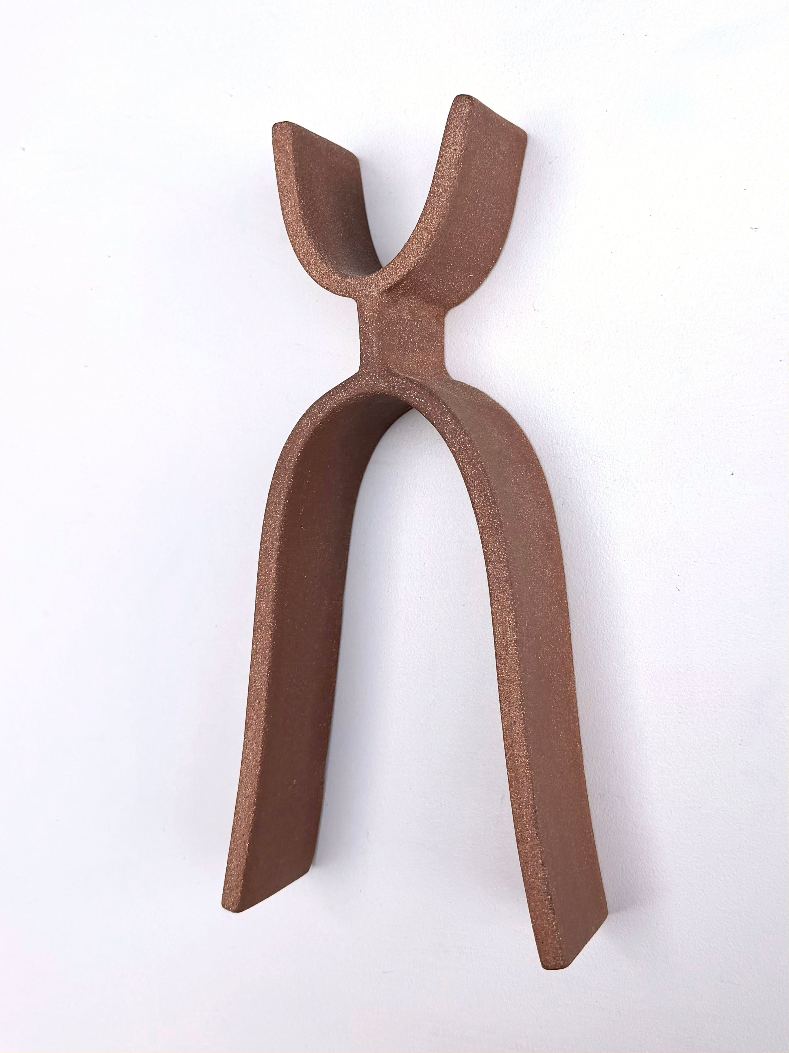 A pair of tongs that are sitting on a white surface.