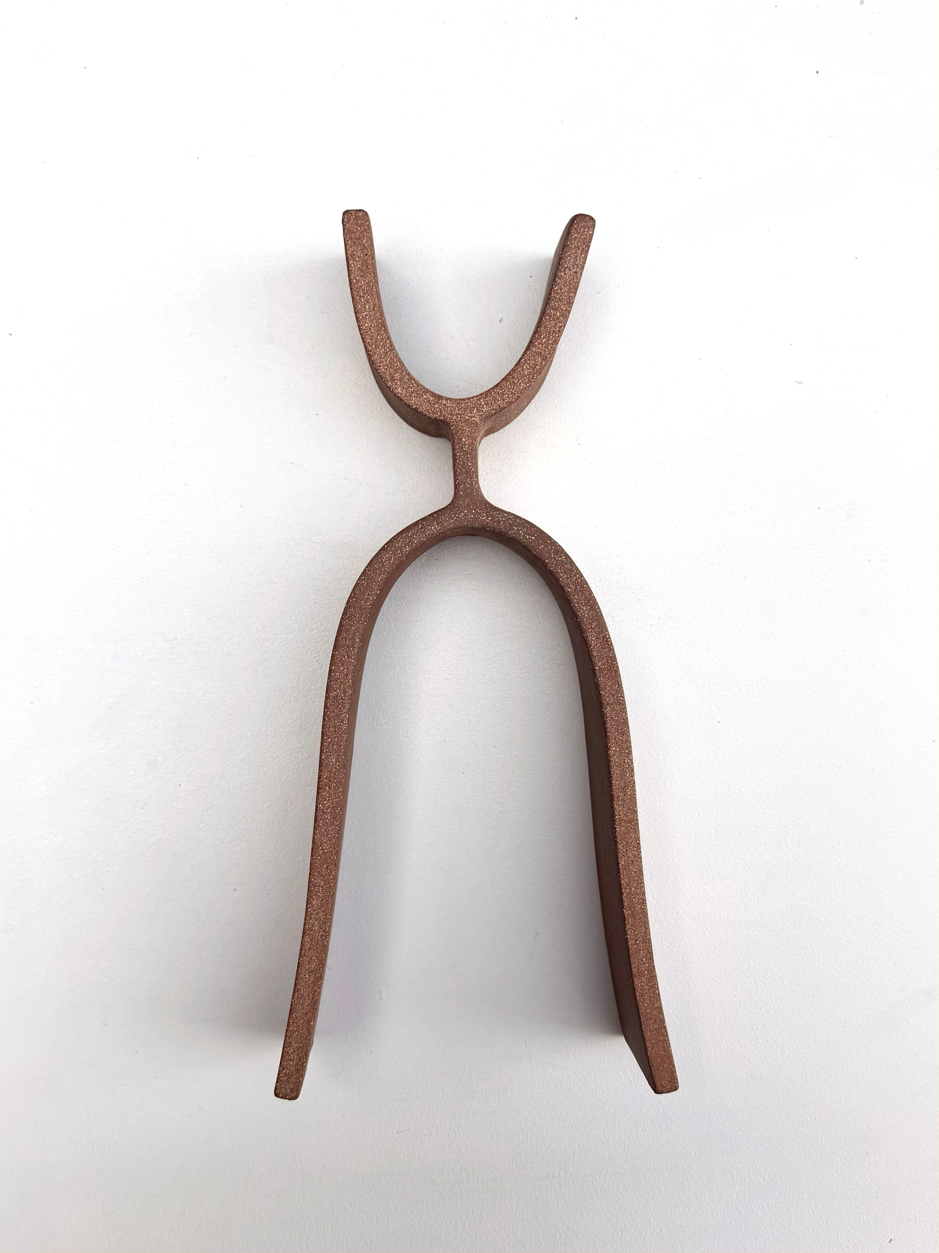 A pair of tongs that are sitting on a white surface.