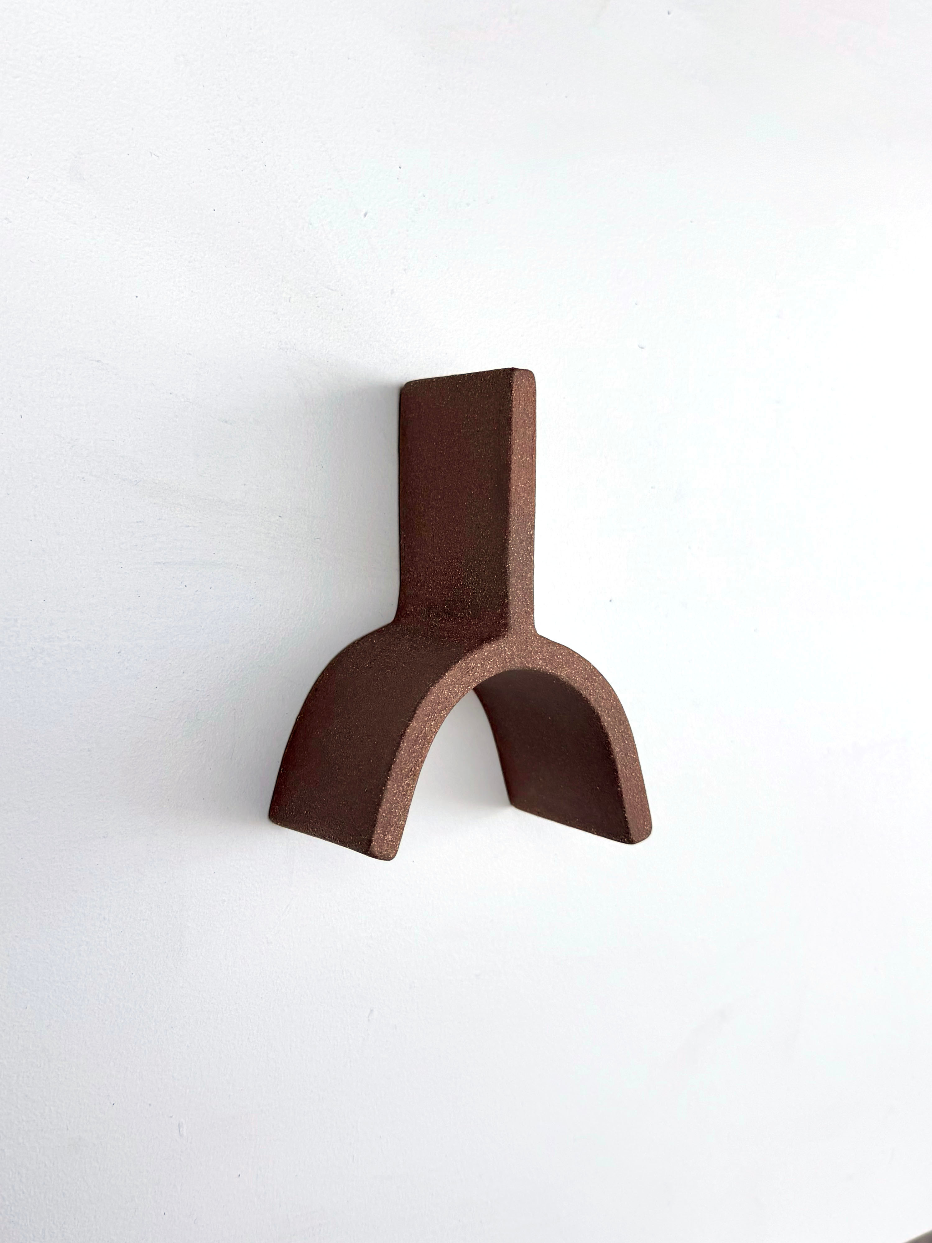 A small metal object on a white surface.