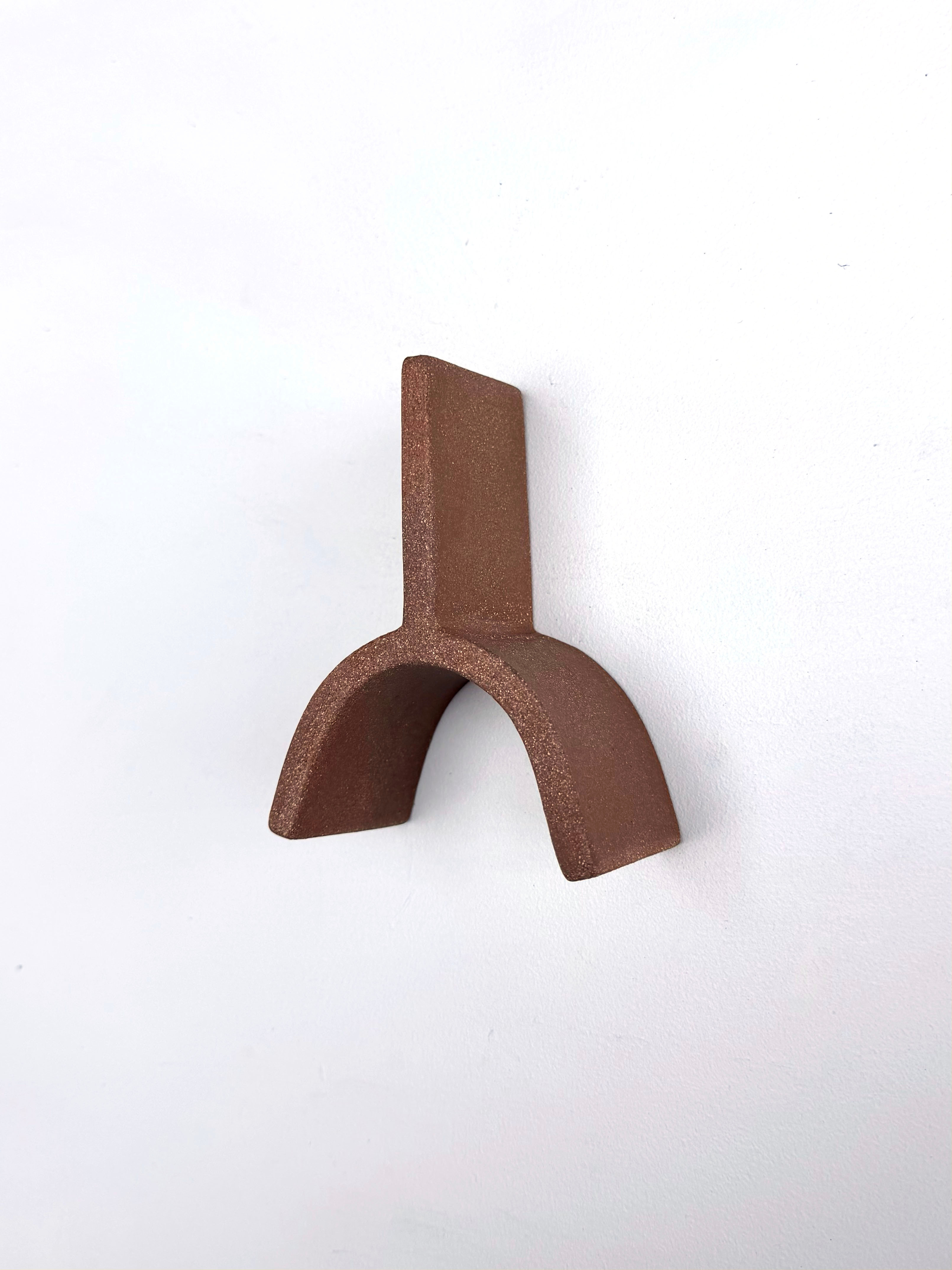 A small metal object on a white surface.