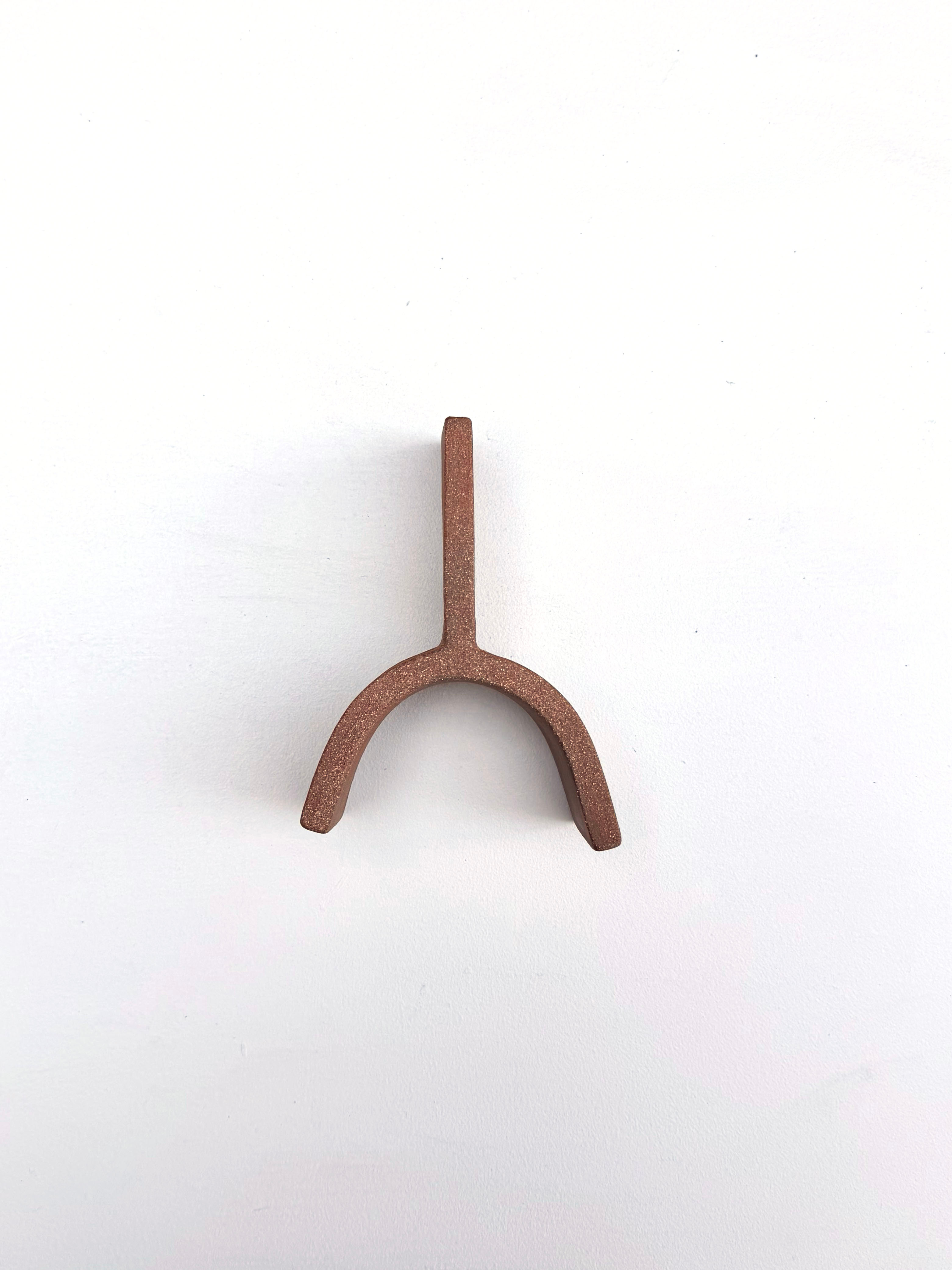 A small metal object on a white surface.