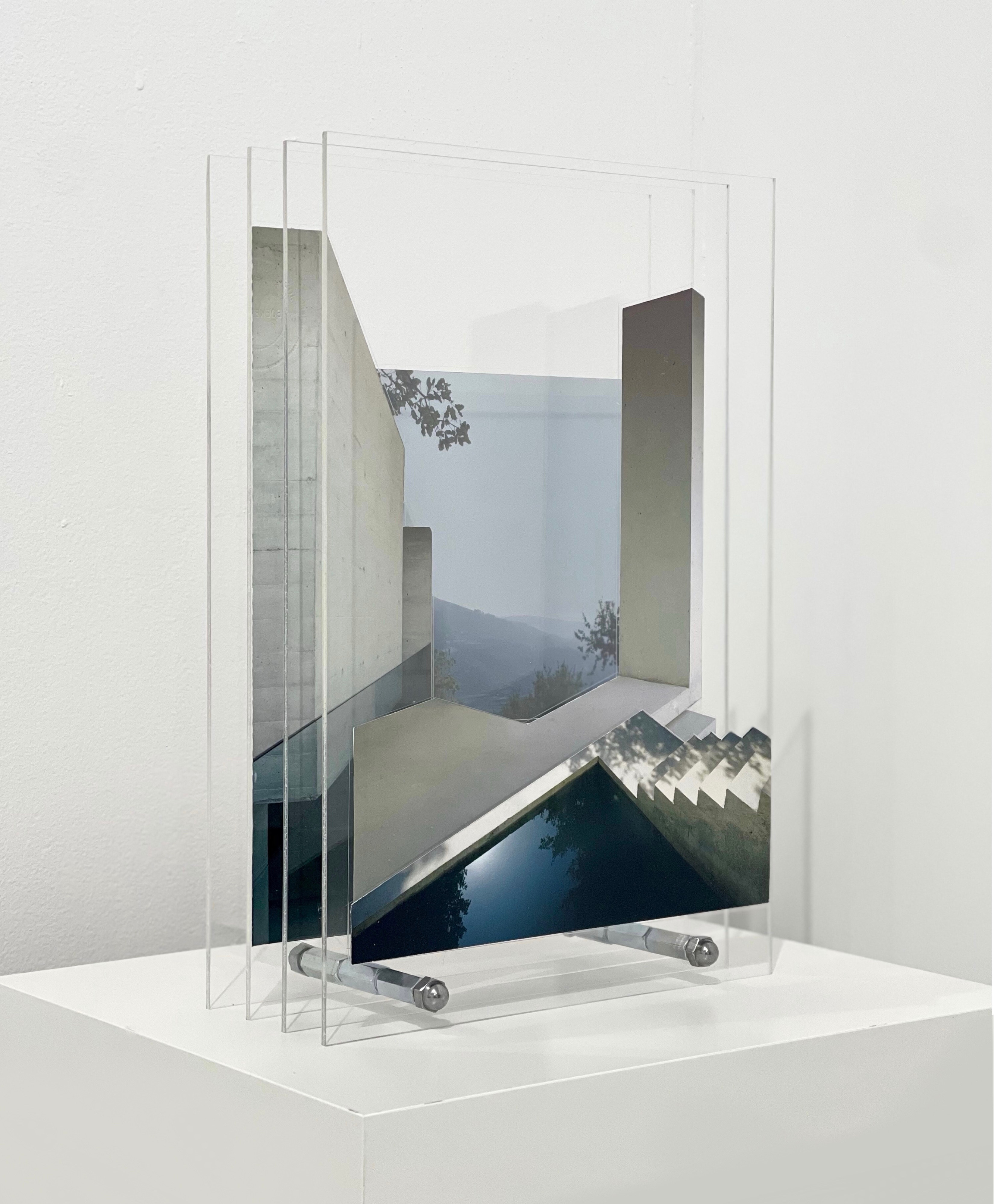A picture of a mirror on a white shelf in a room.