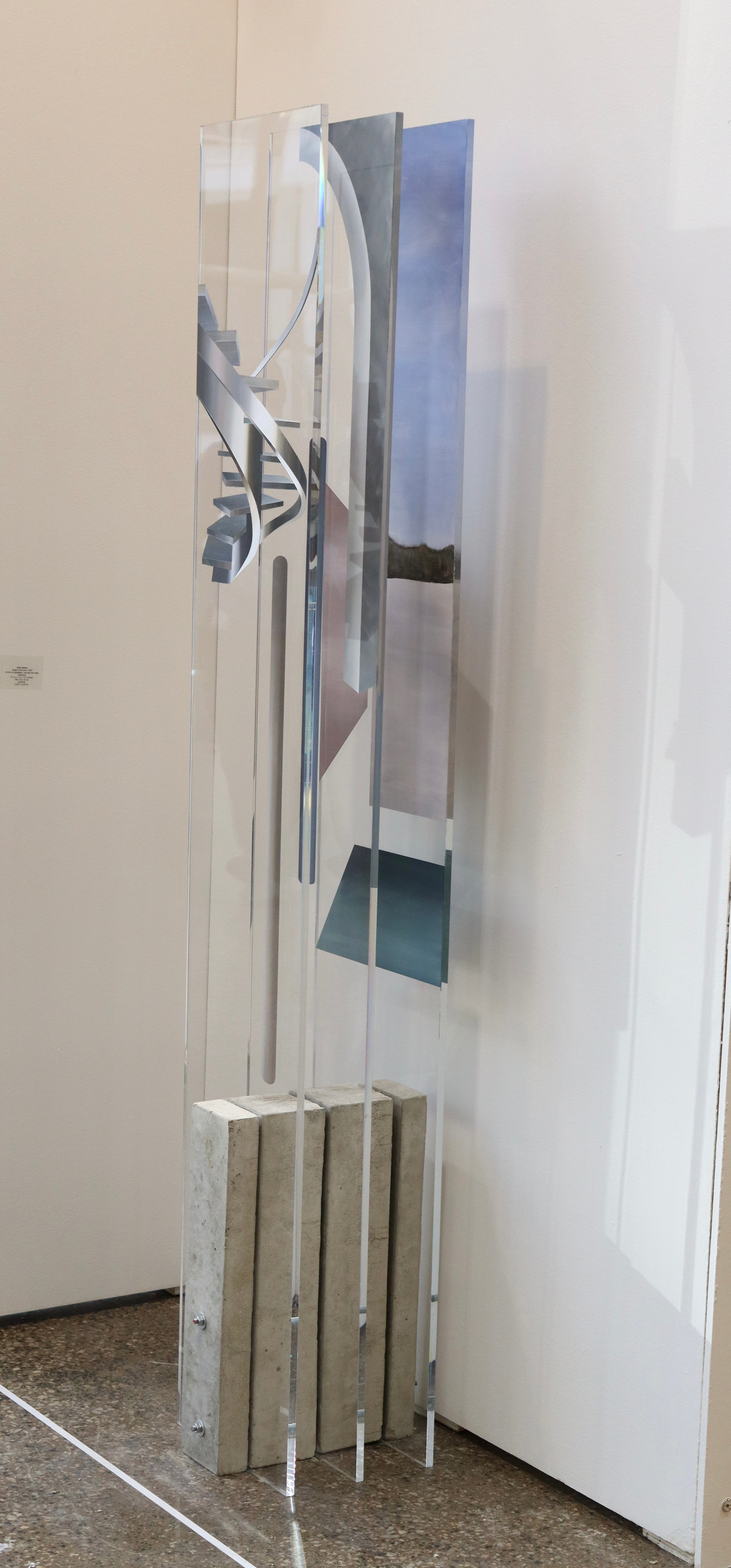 A picture of a sculpture on a pedestal in a room.