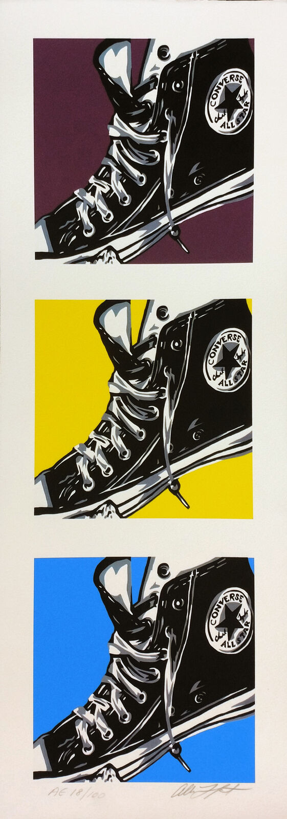 A pair of black converse sneakers on a colorful background.