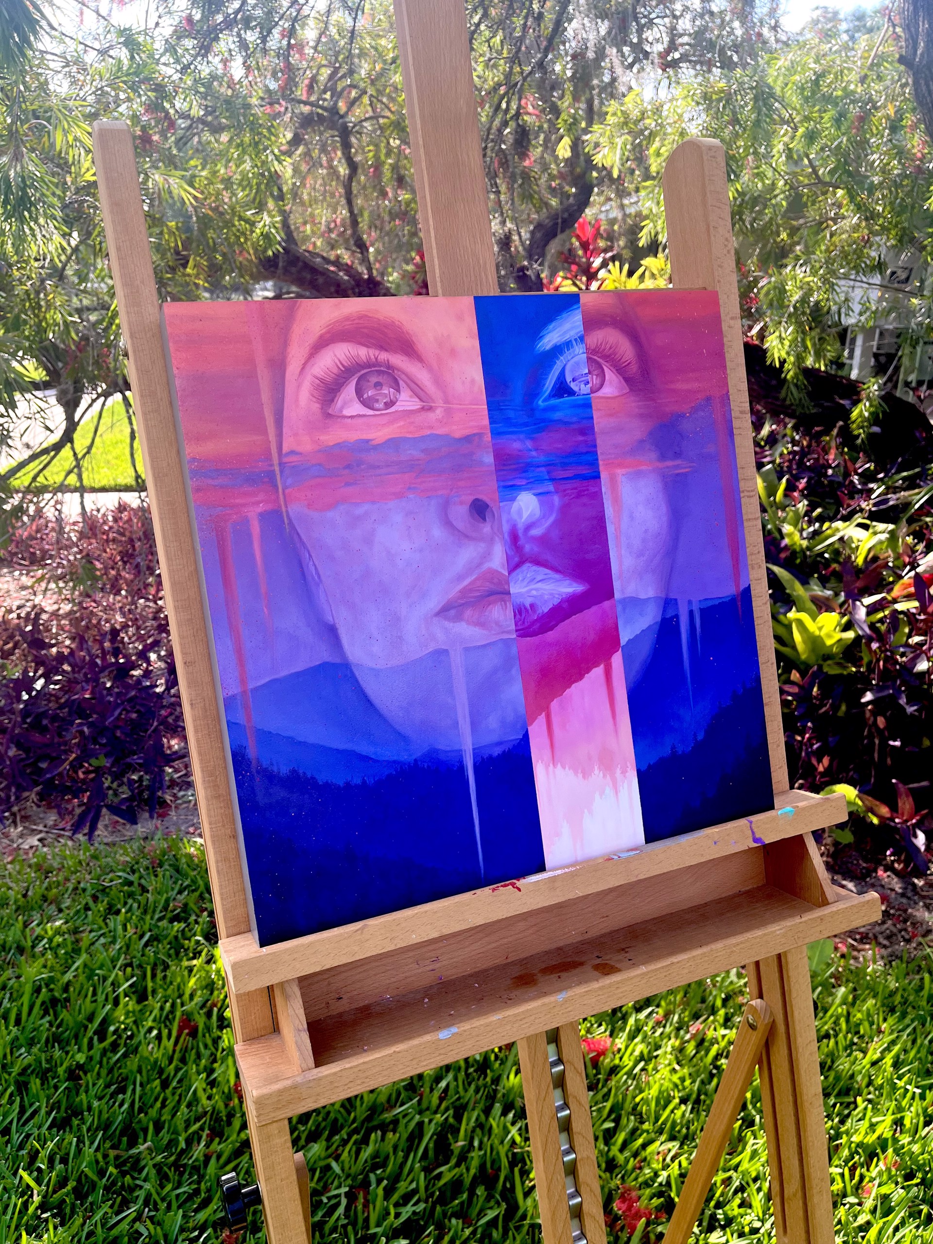 A painting of a woman's face with a mountain in the background.