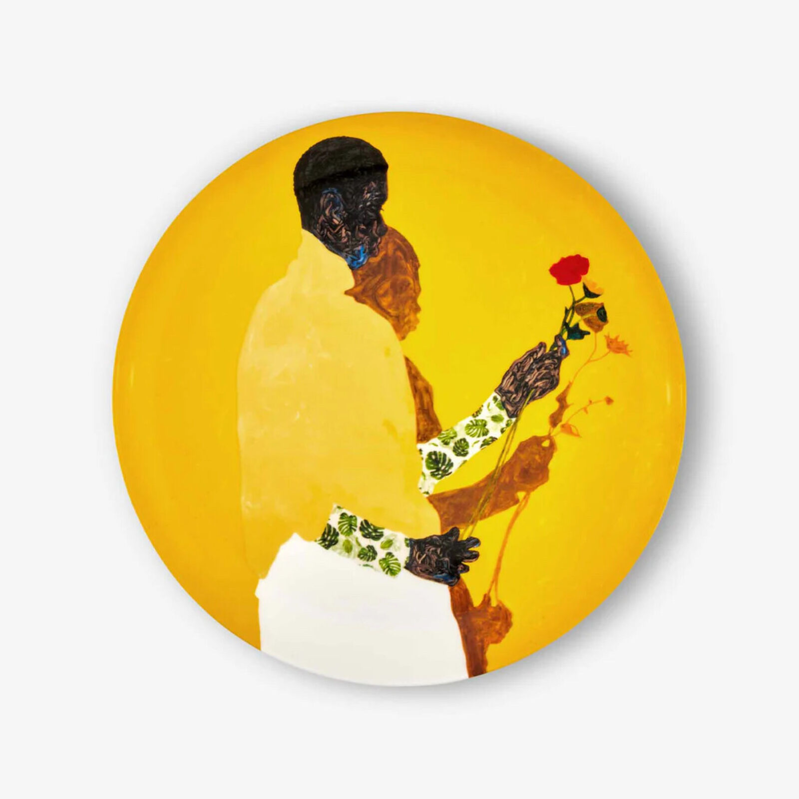A yellow plate with a painting of a man holding a flower.