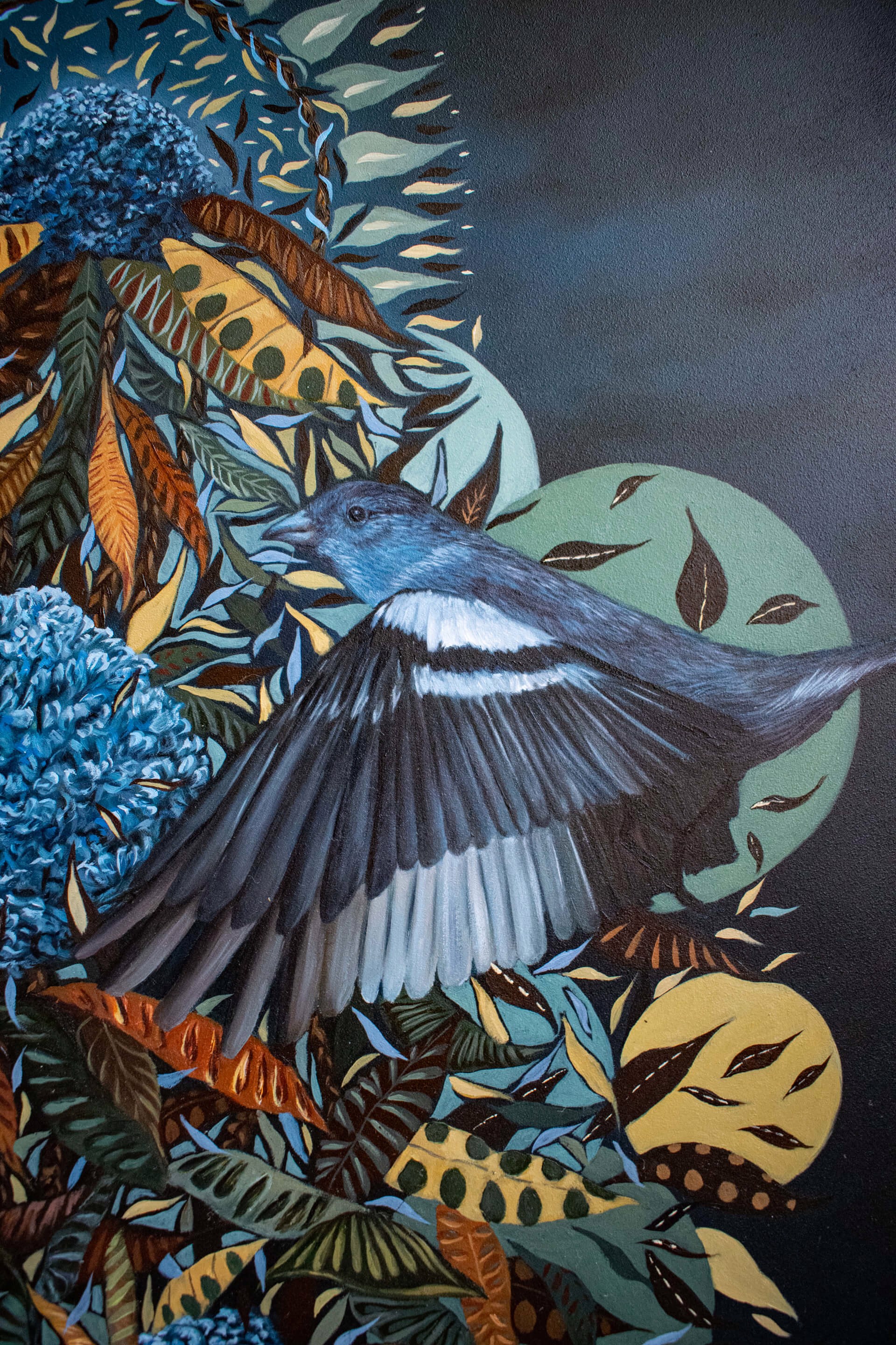 A painting of a hand holding a bunch of flowers and birds.