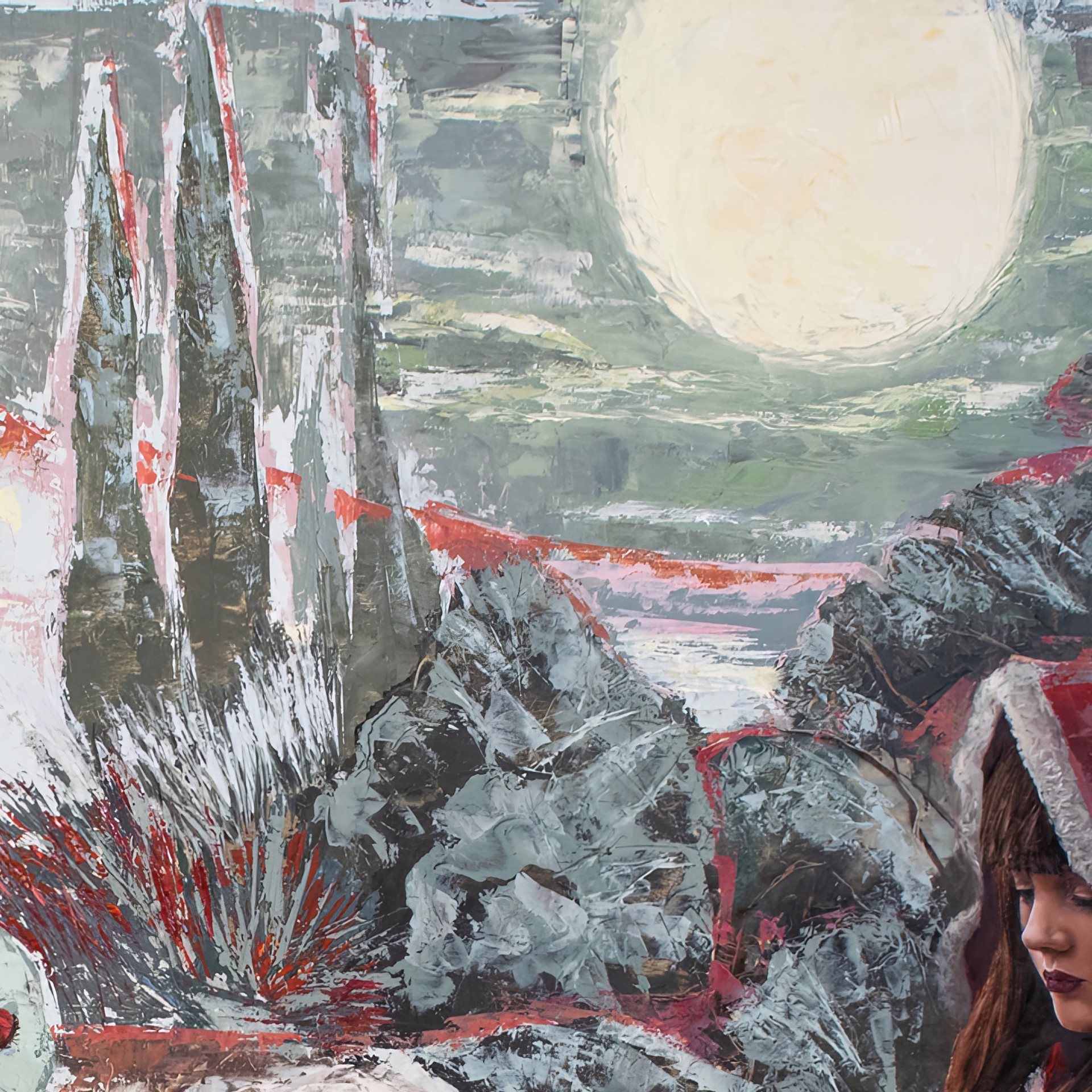 A figure in a red hooded cloak sits by a tree under a full moon, surrounded by a surreal landscape of abstract houses and floating spheres.