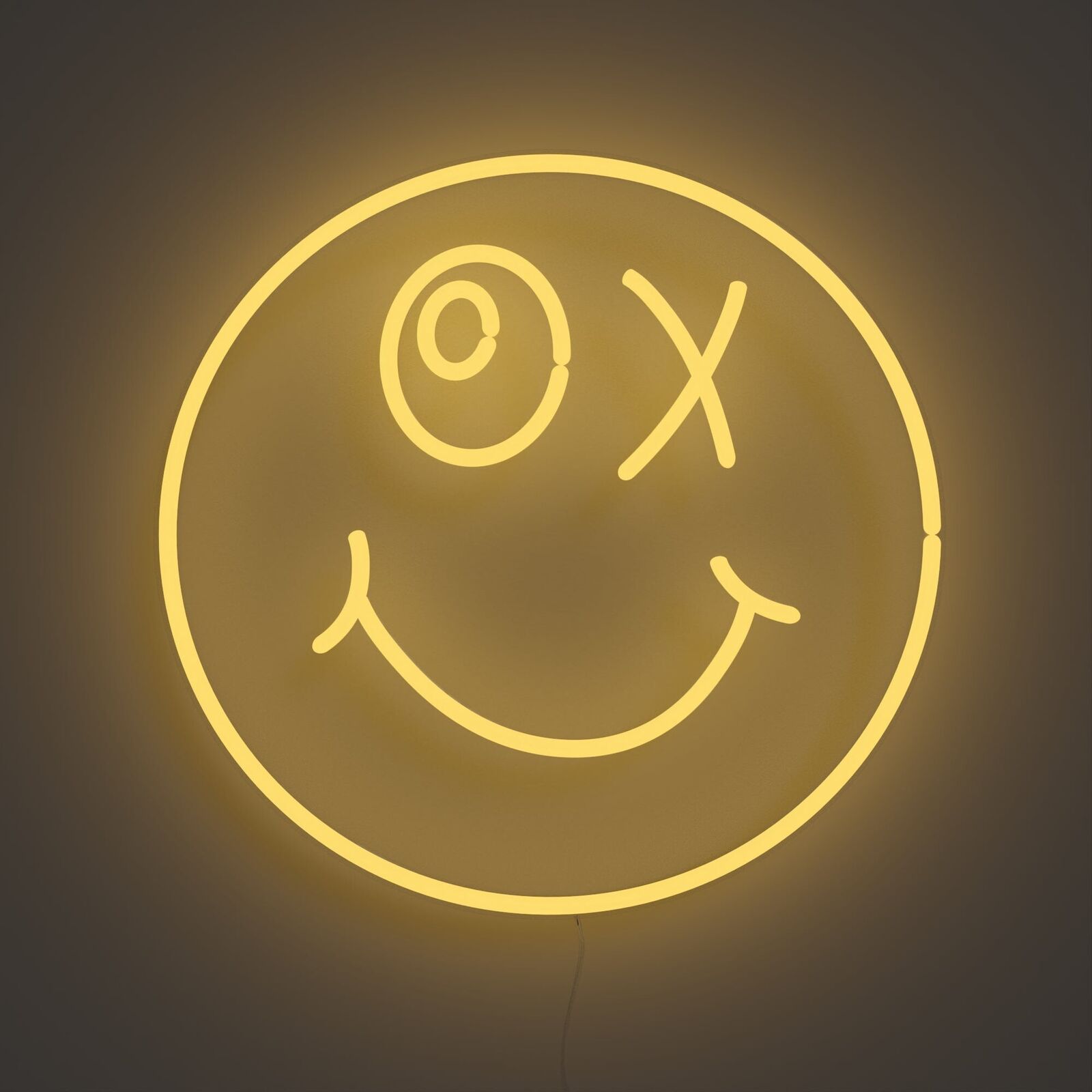 A smiley face neon sign with a smile on it.
