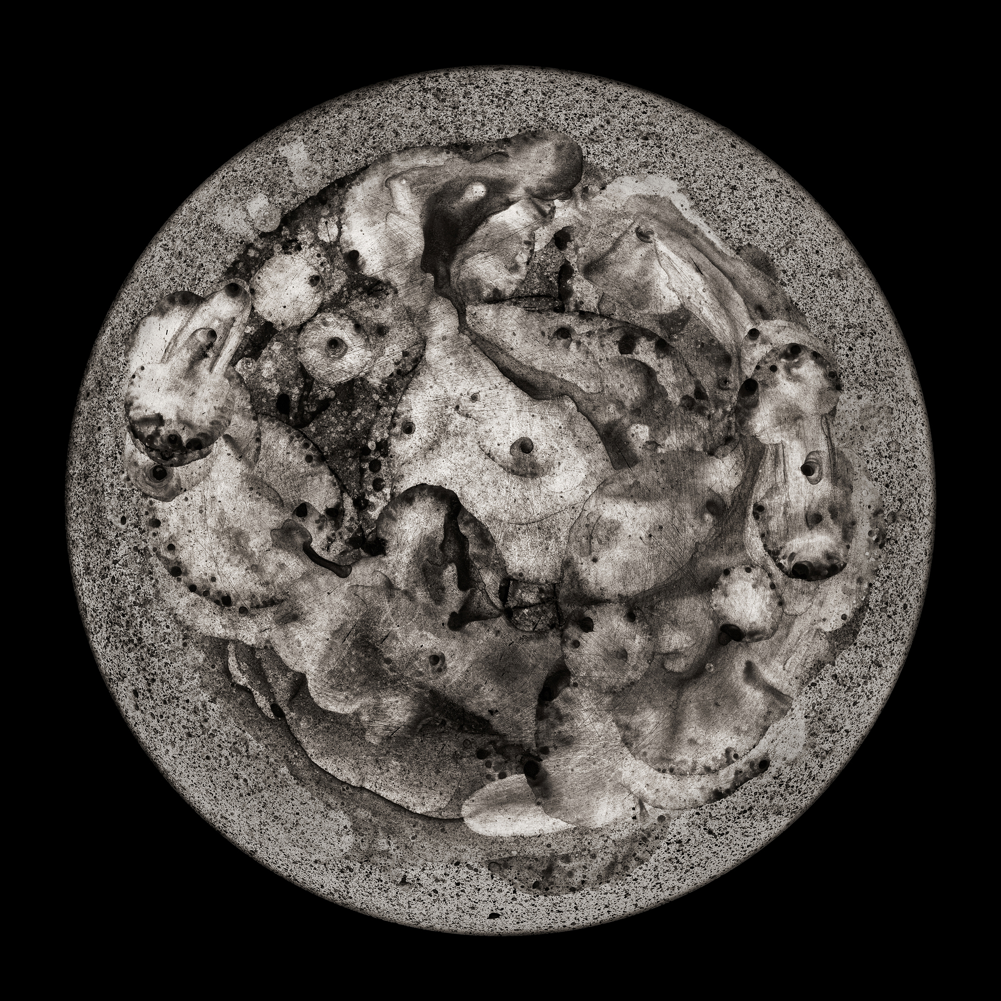 A black and white image of a circular object on a black background.