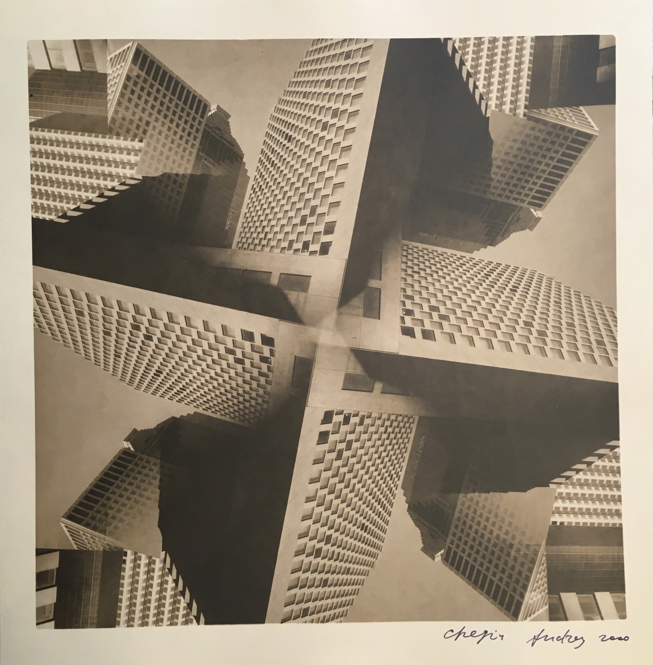 A black and white photo of a group of tall buildings.