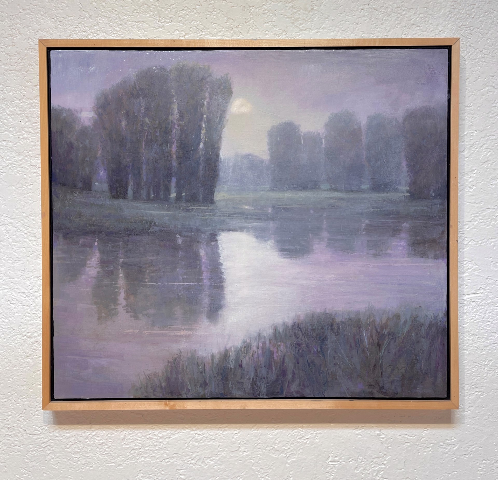 A moody landscape painting of a misty riverbank at twilight.