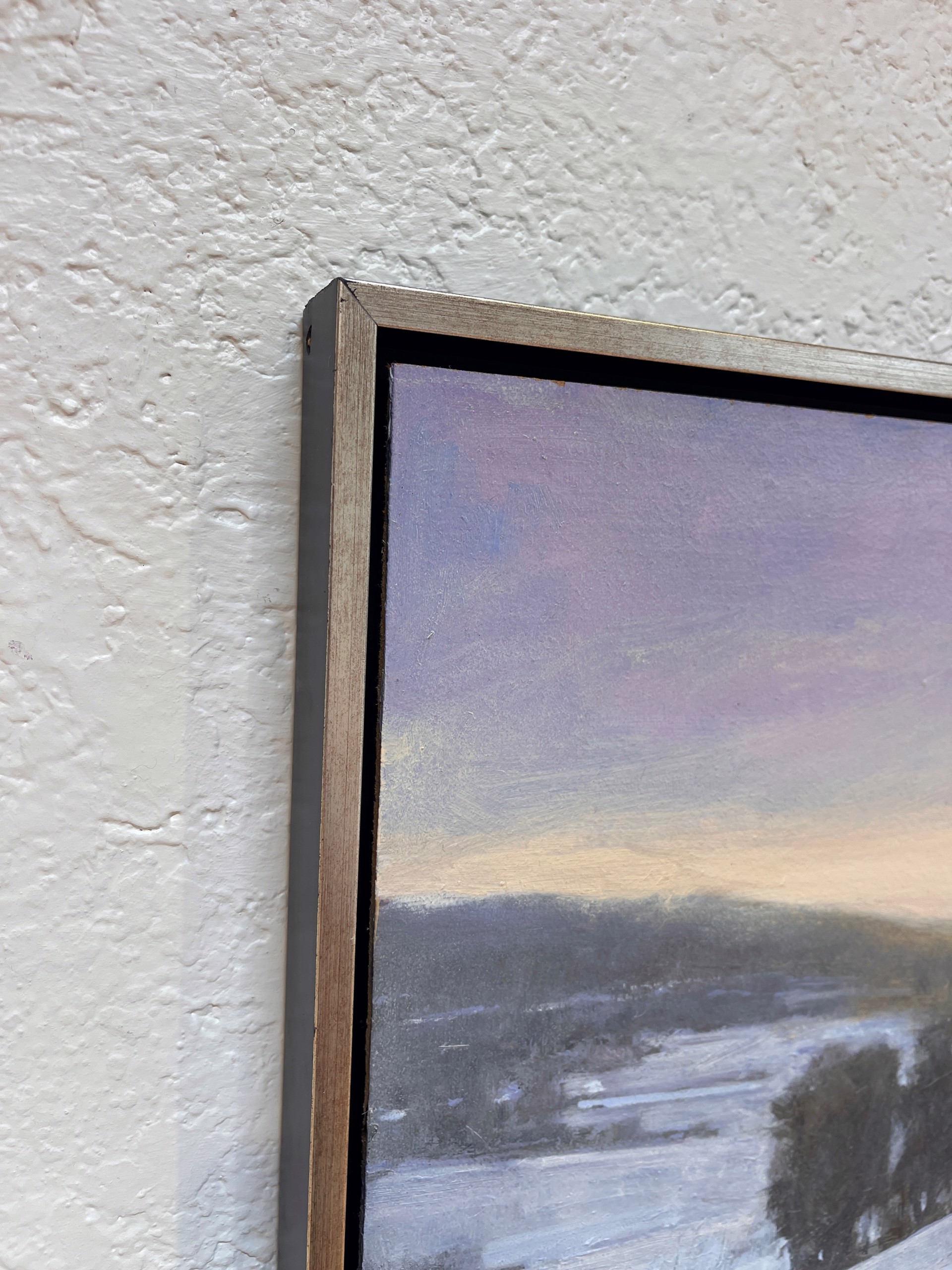 A painting of a snowy landscape with trees in the distance.