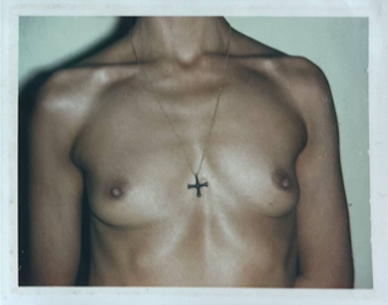 A woman with a cross on her chest. 
