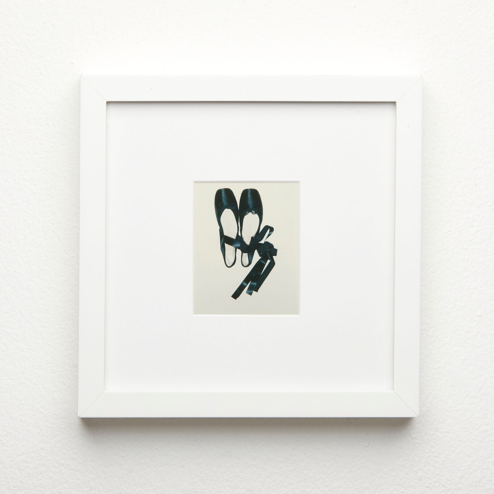 A picture of a pair of shoes hanging on a wall.