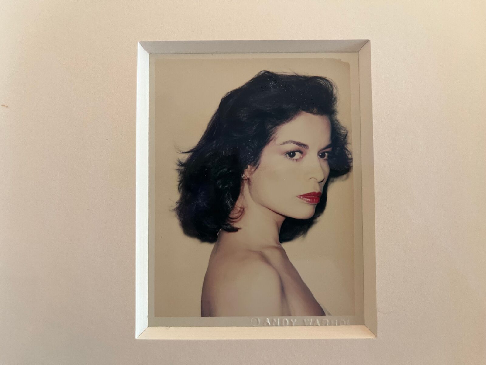 A picture of a woman with dark hair and red lipstick.