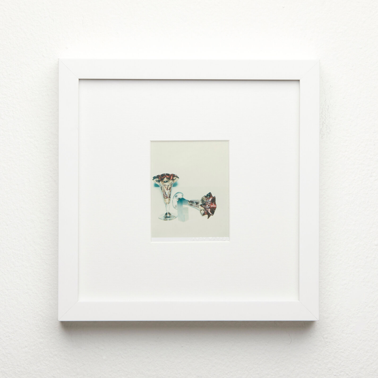 A picture of a white frame hanging on a wall.