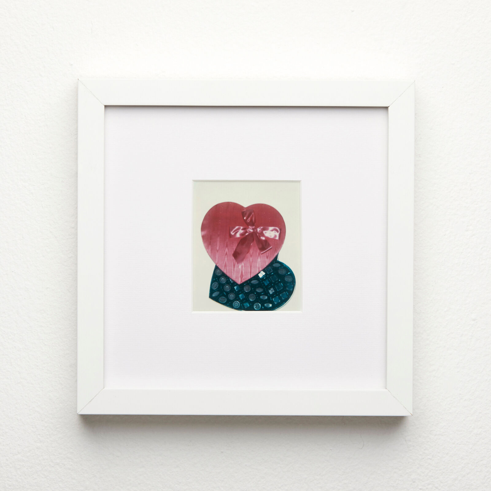 A picture of a red heart with a bow on it.