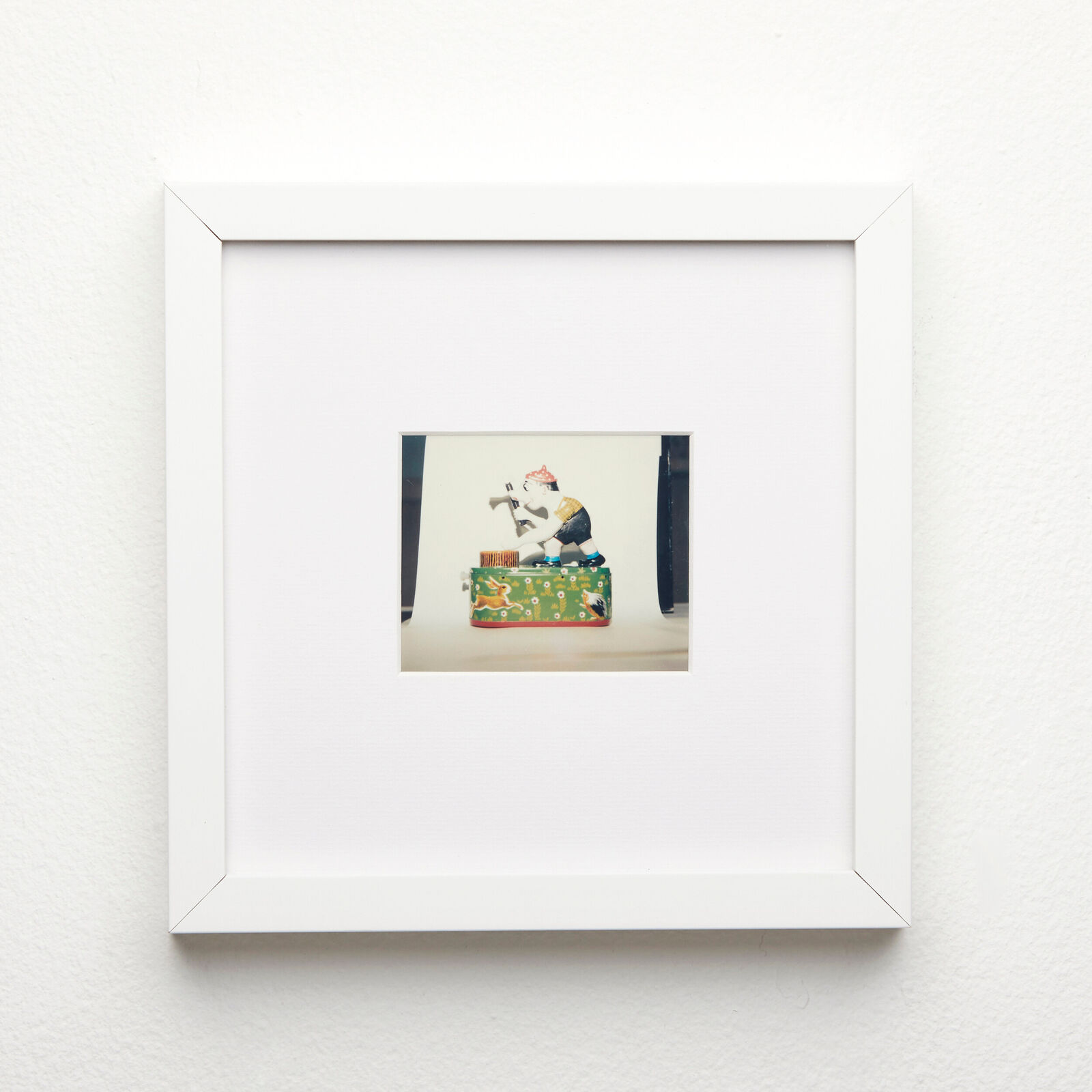 A picture of a cat sitting on top of a box.