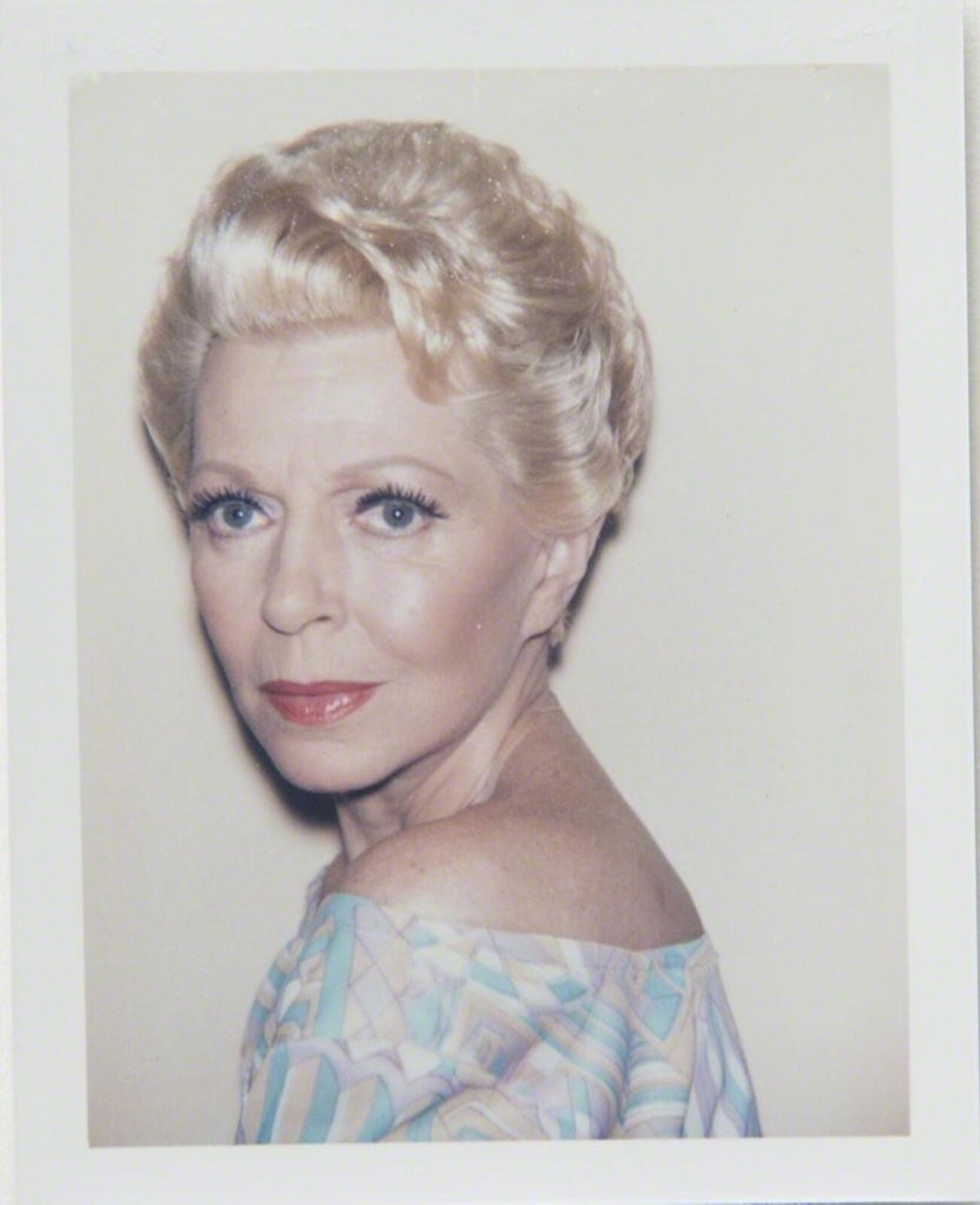A polaroid photo of a woman with blonde hair.