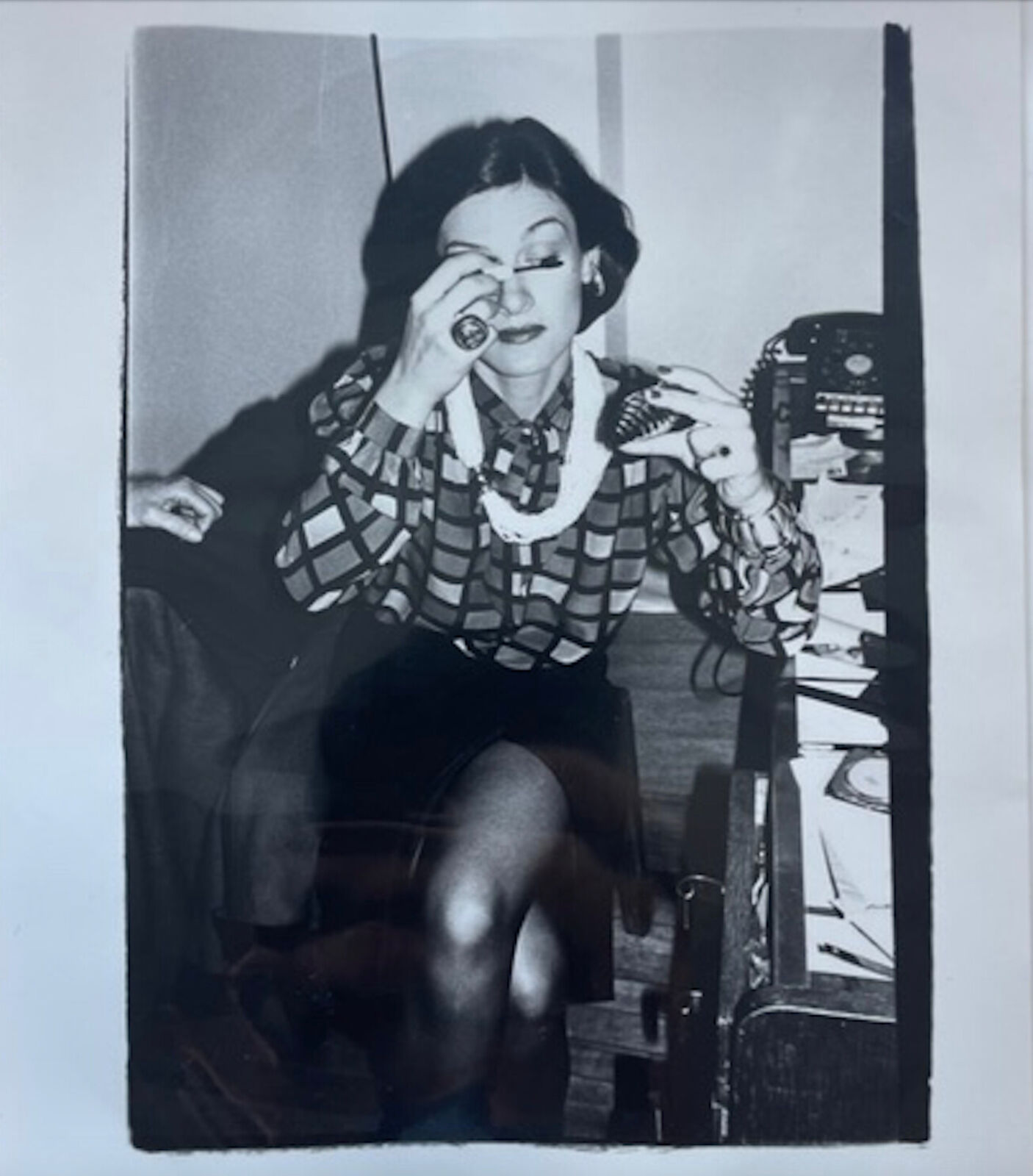 A black and white photo of a woman sitting in a chair.