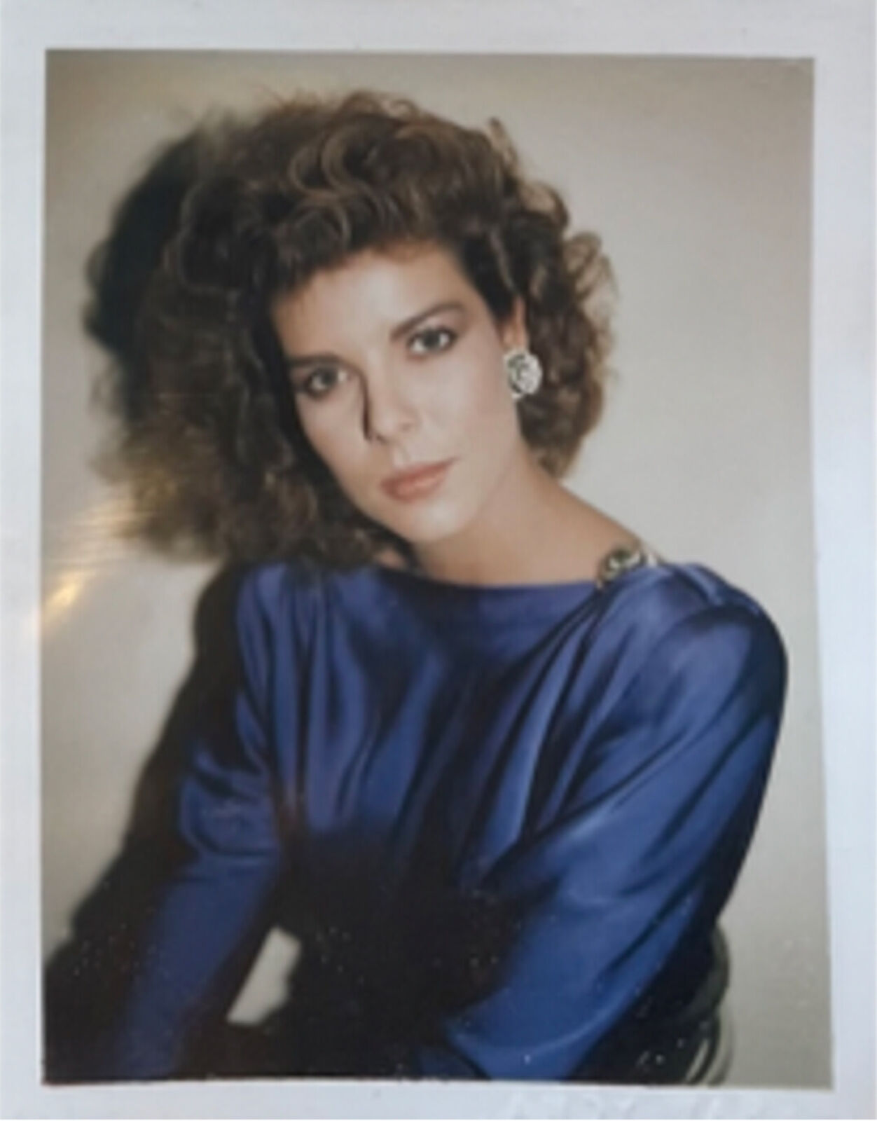 A woman in a blue dress posing for a picture.