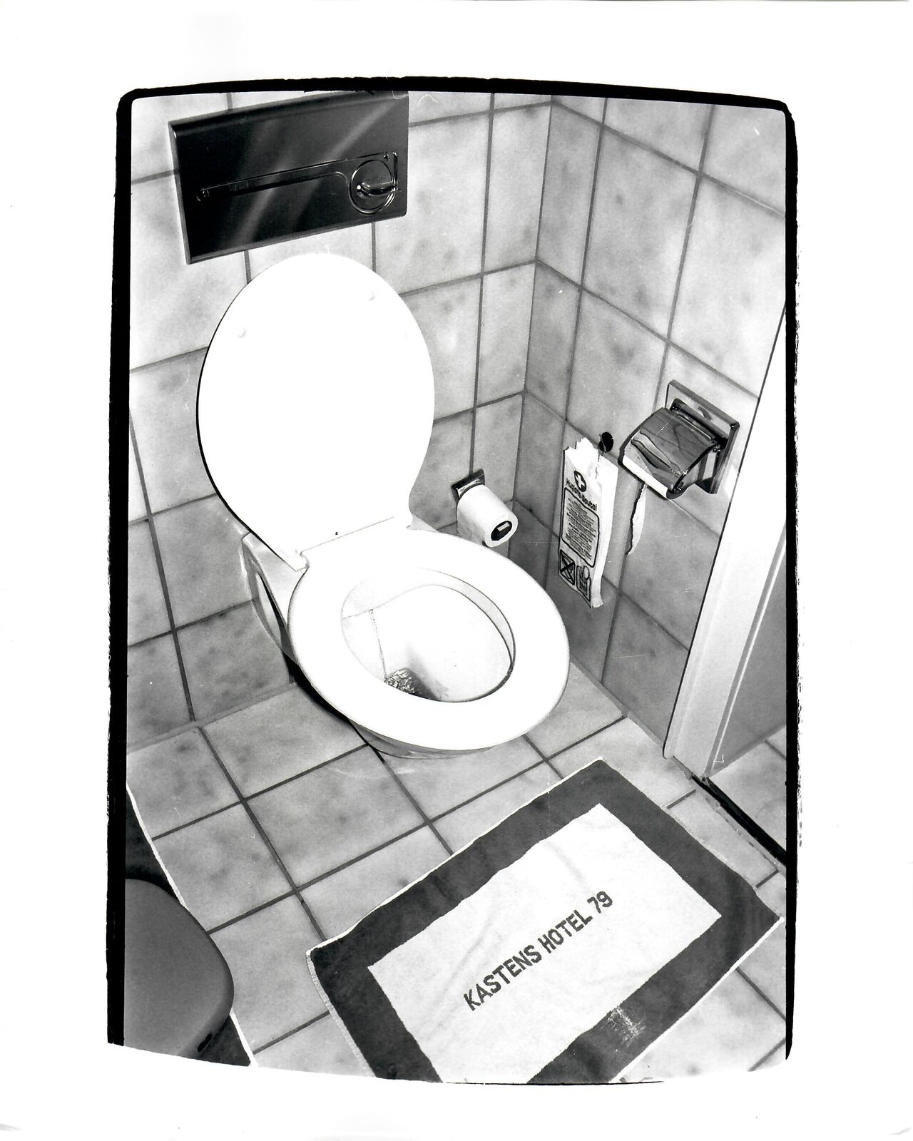 A black and white photo of a toilet in a bathroom.