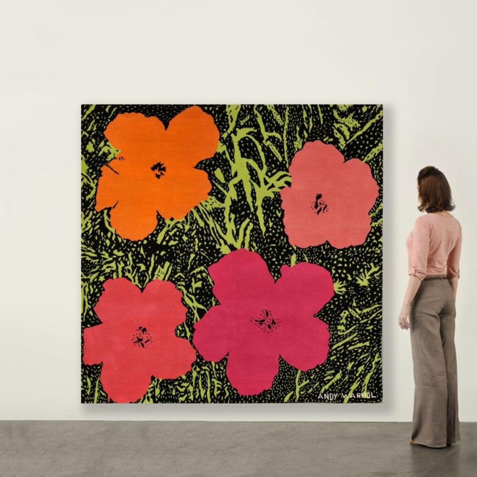 A painting of three red and orange flowers on a green background.