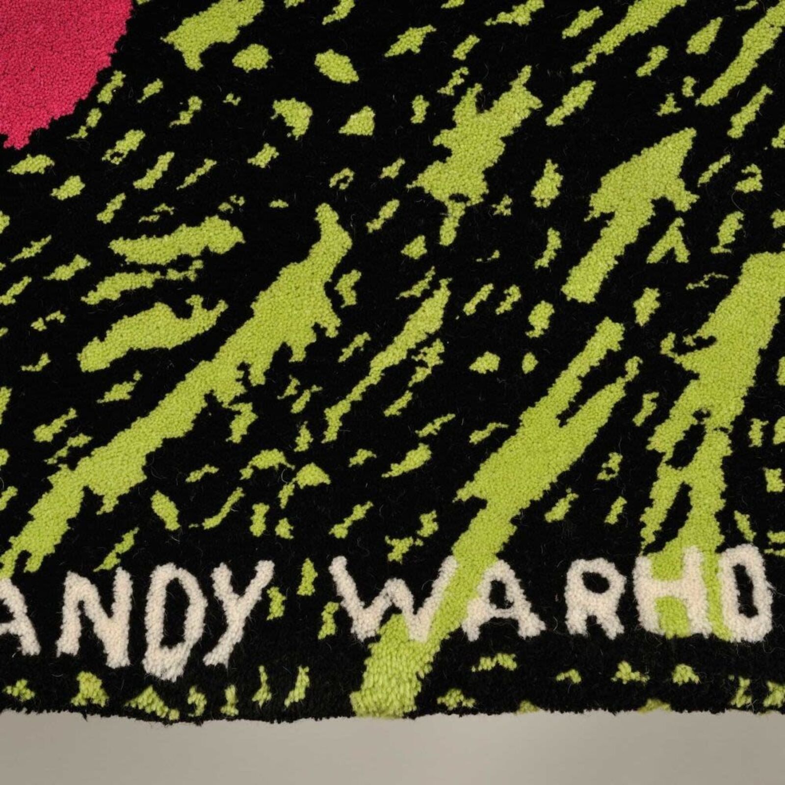 A painting of three red and orange flowers on a green background.