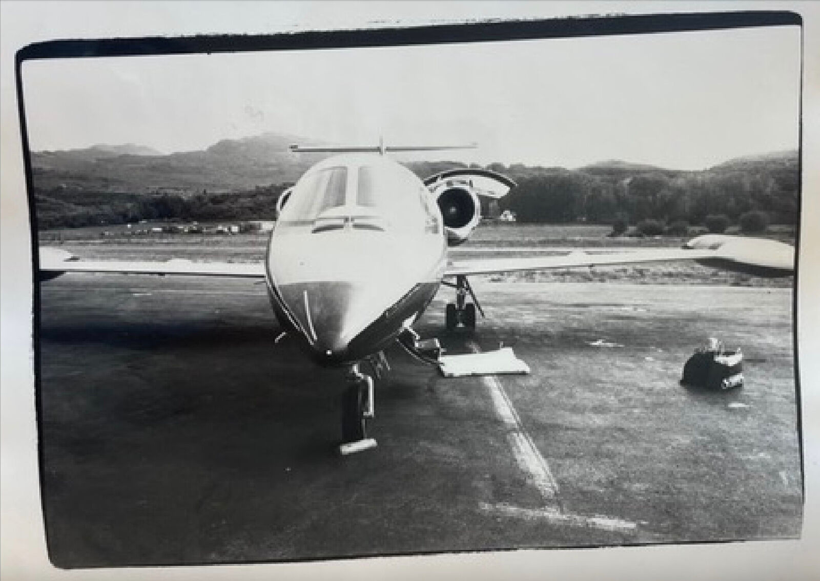 A black and white photo of an airplane on a runway.