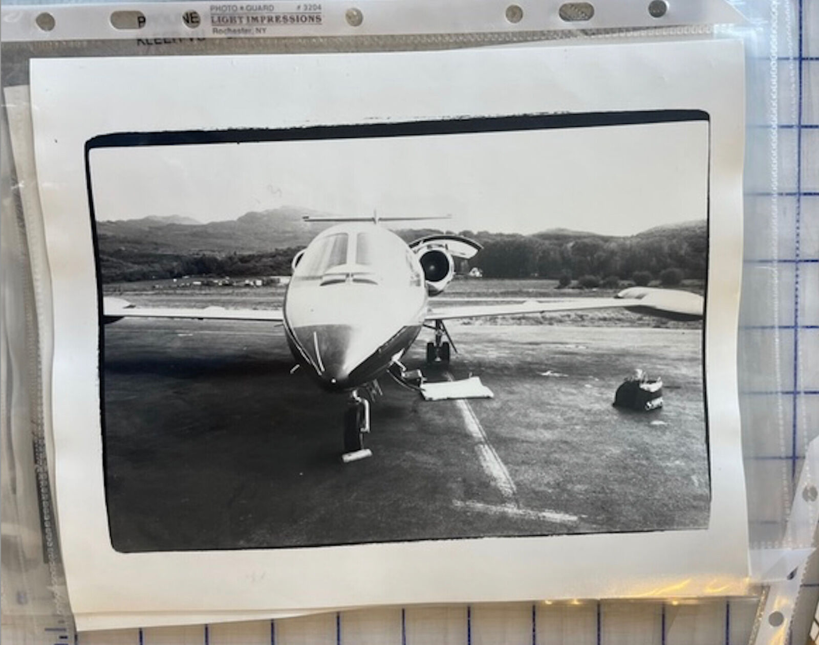 A black and white photo of an airplane on a runway.