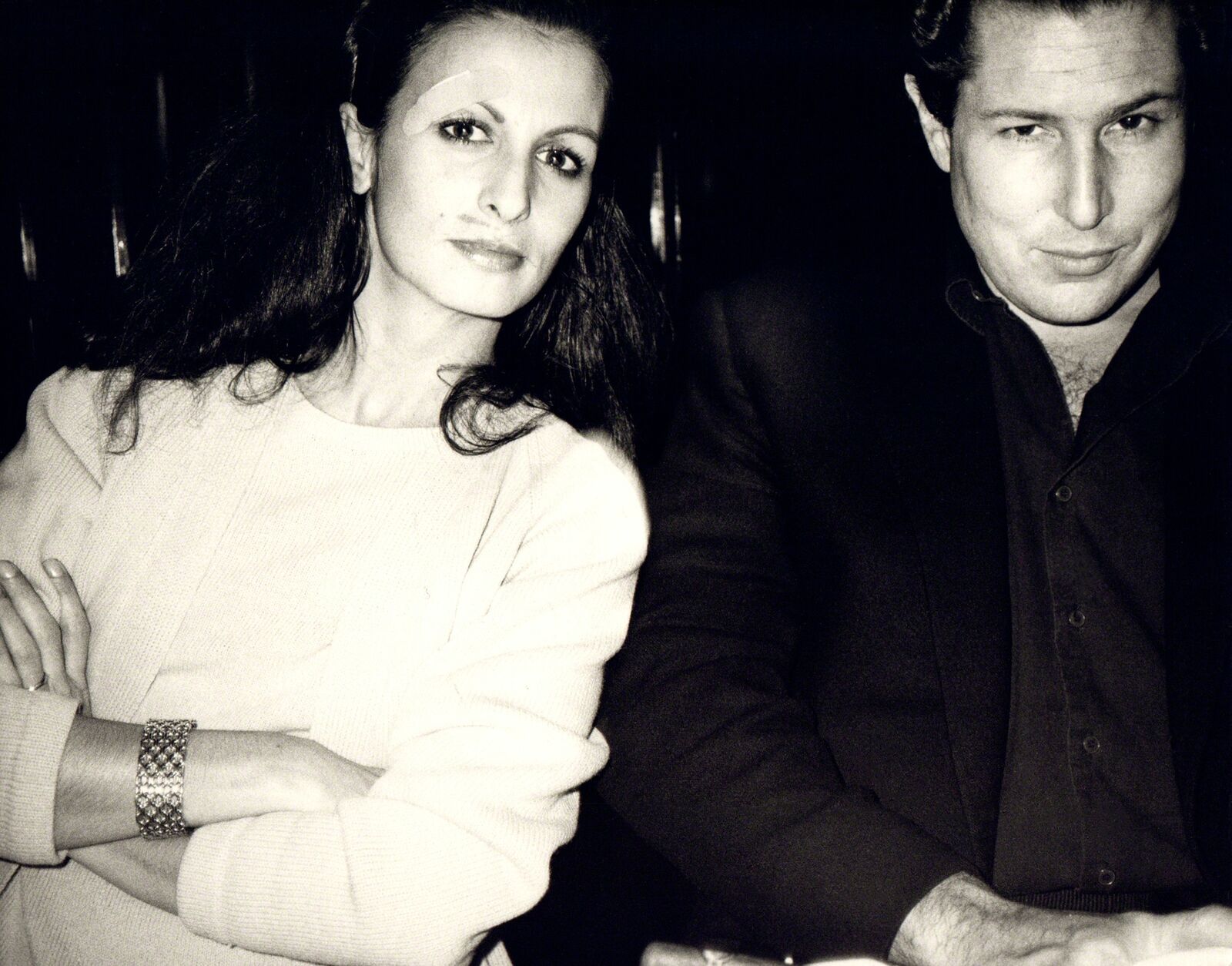 A man and a woman sitting next to each other.