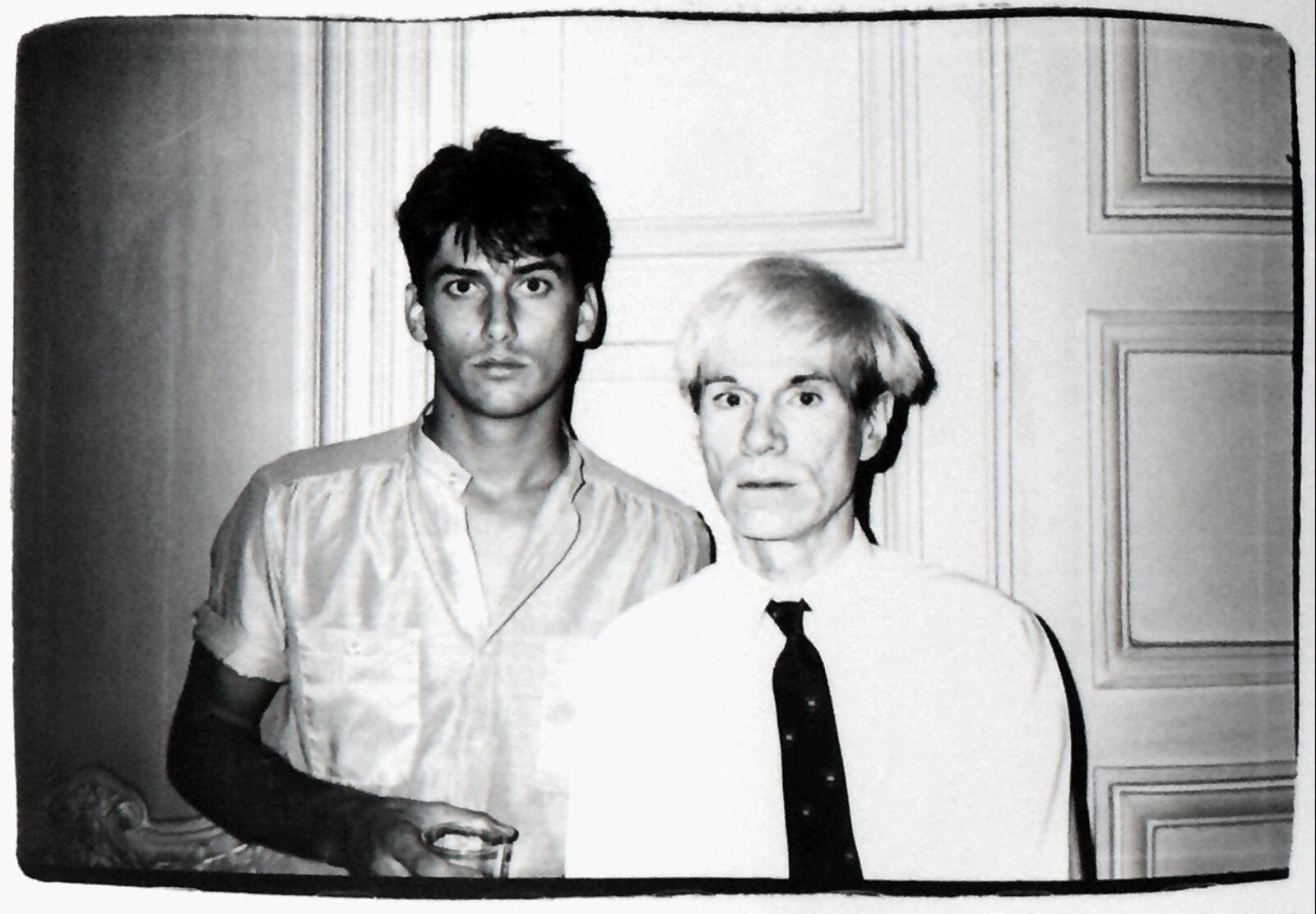 A black and white photo of two men standing next to each other.