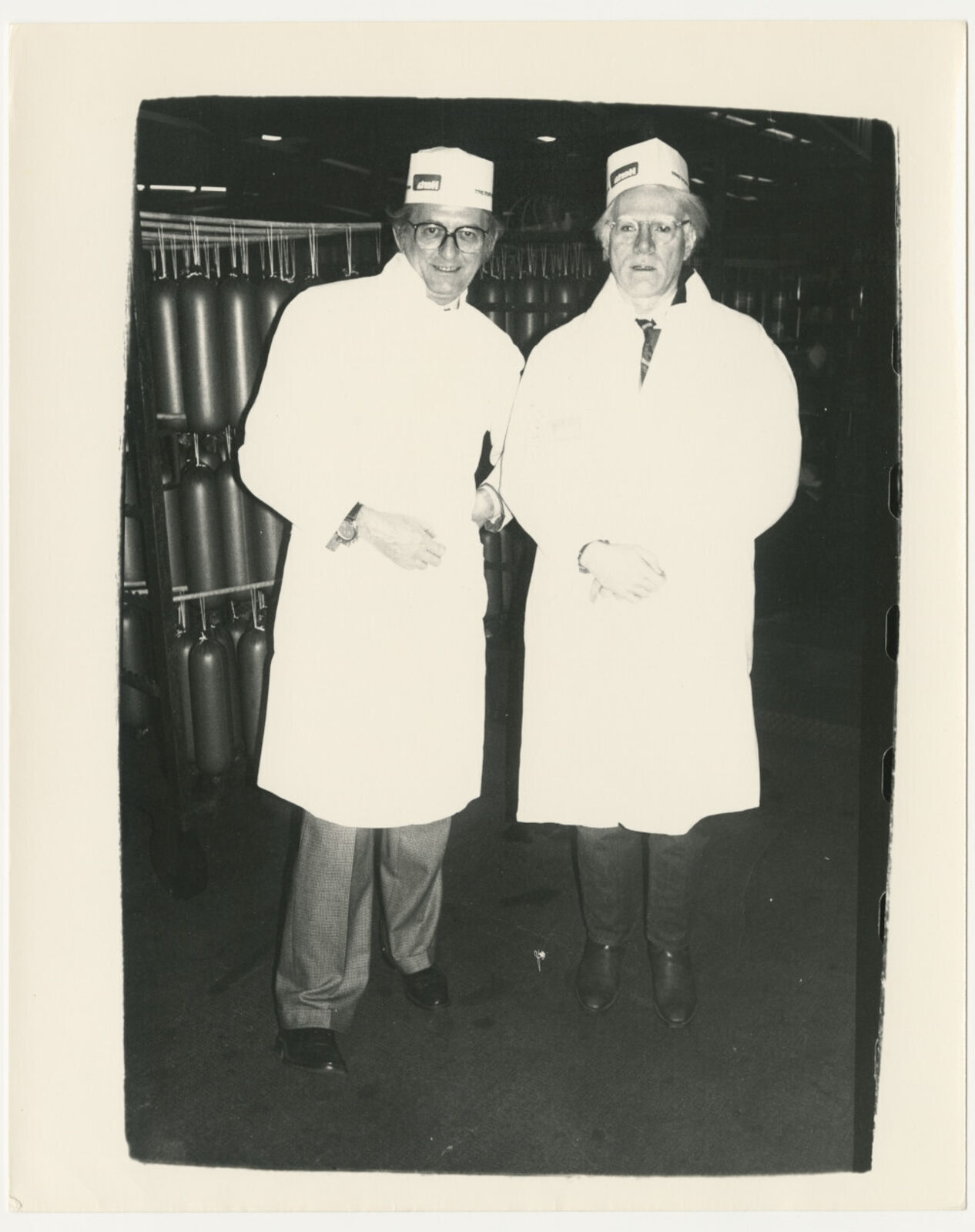A black and white photo of two men in lab coats.