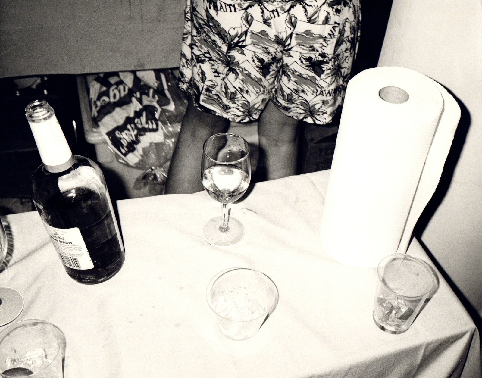 A table topped with glasses and a bottle of wine.