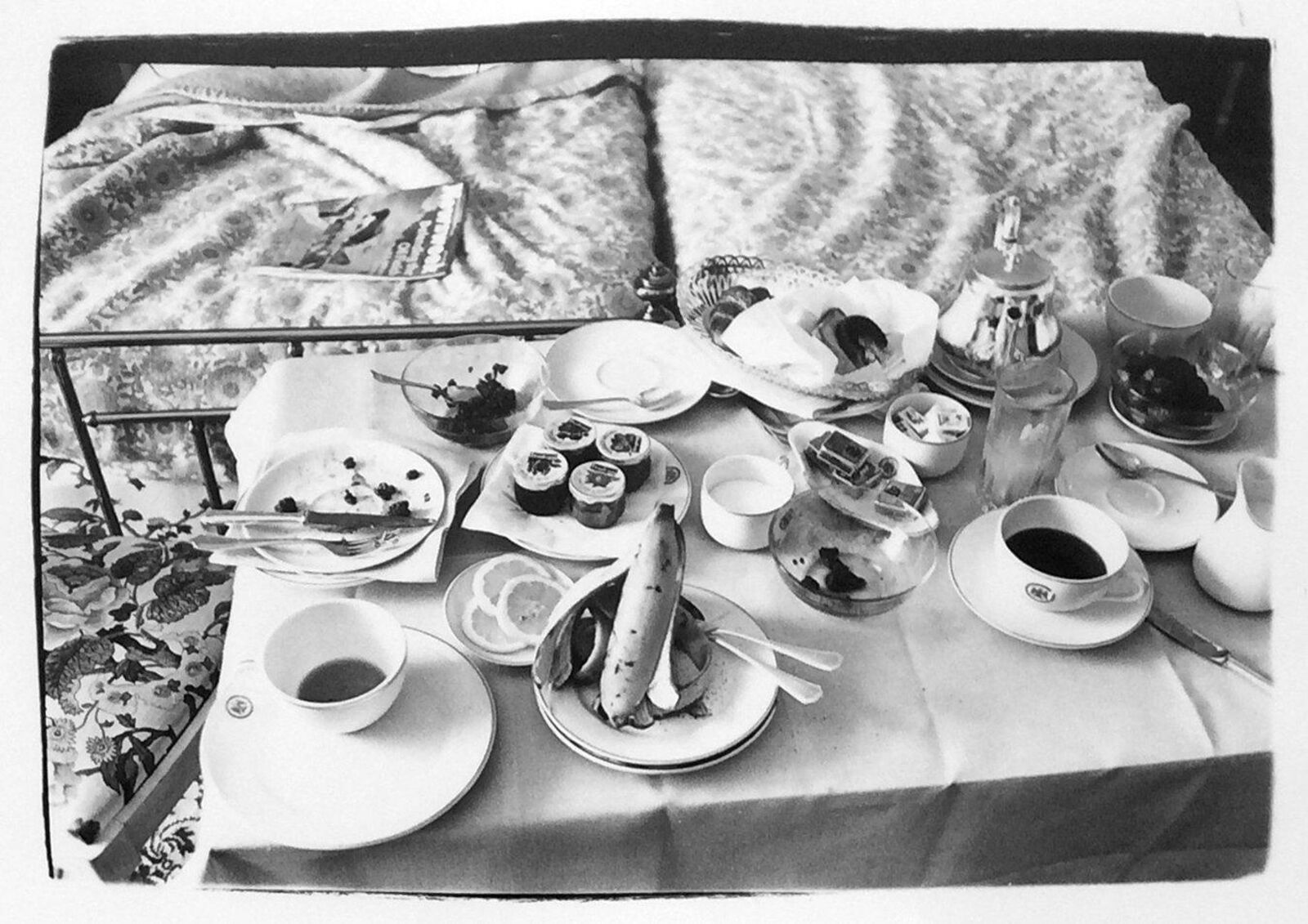 A table topped with plates of food and cups of tea.