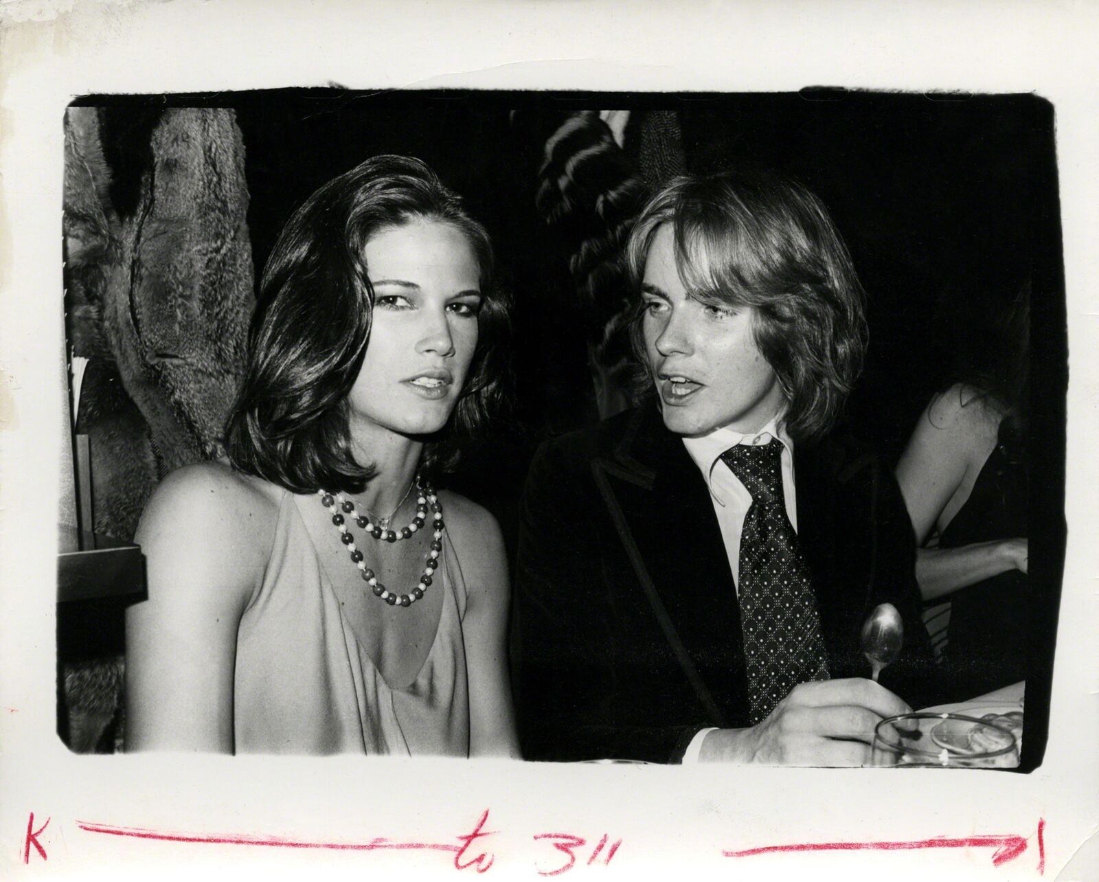 A black and white photo of a man and a woman.