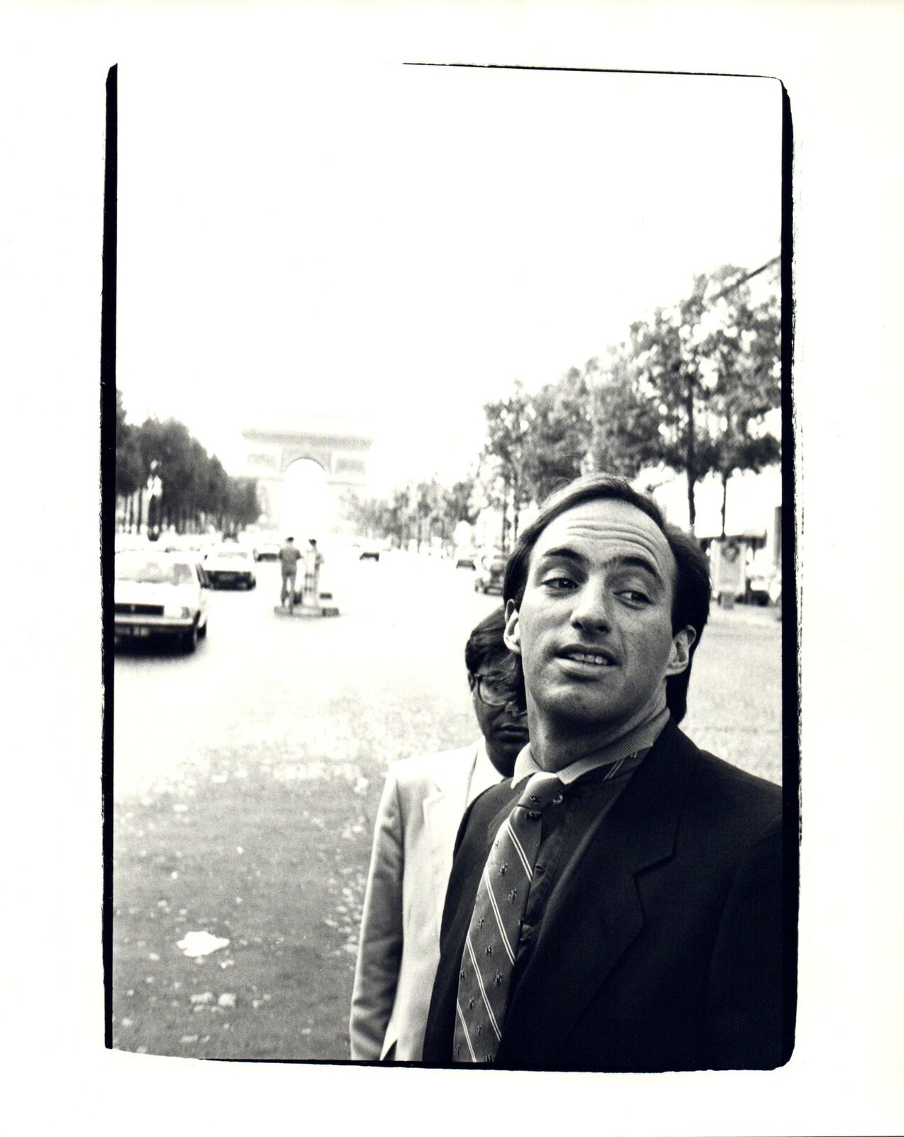 A black and white photo of a man in a suit and tie.