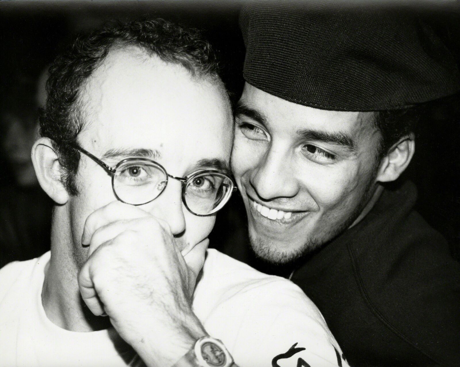 A black and white photo of two men smiling at the camera.