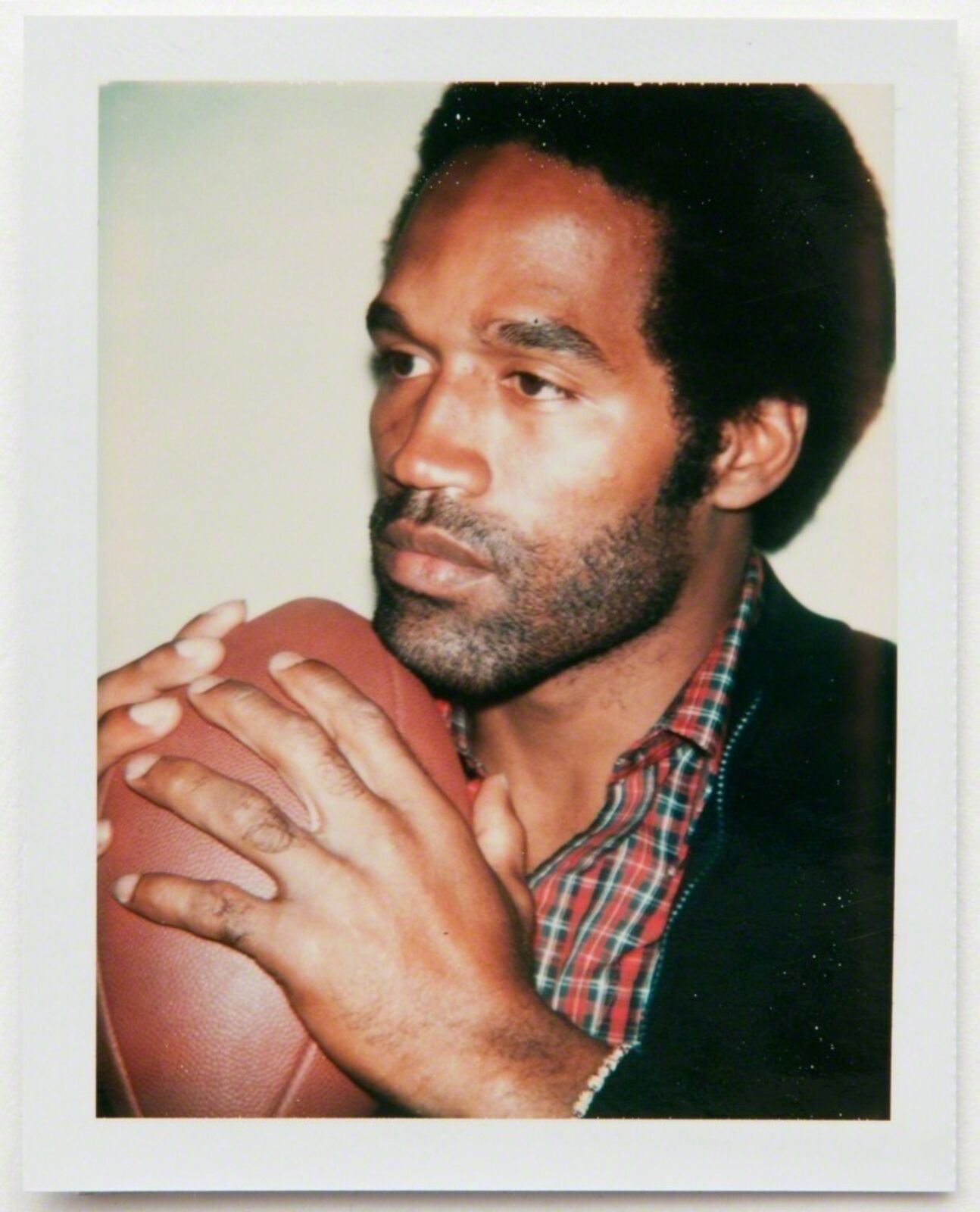 A man holding a football in his hands. 