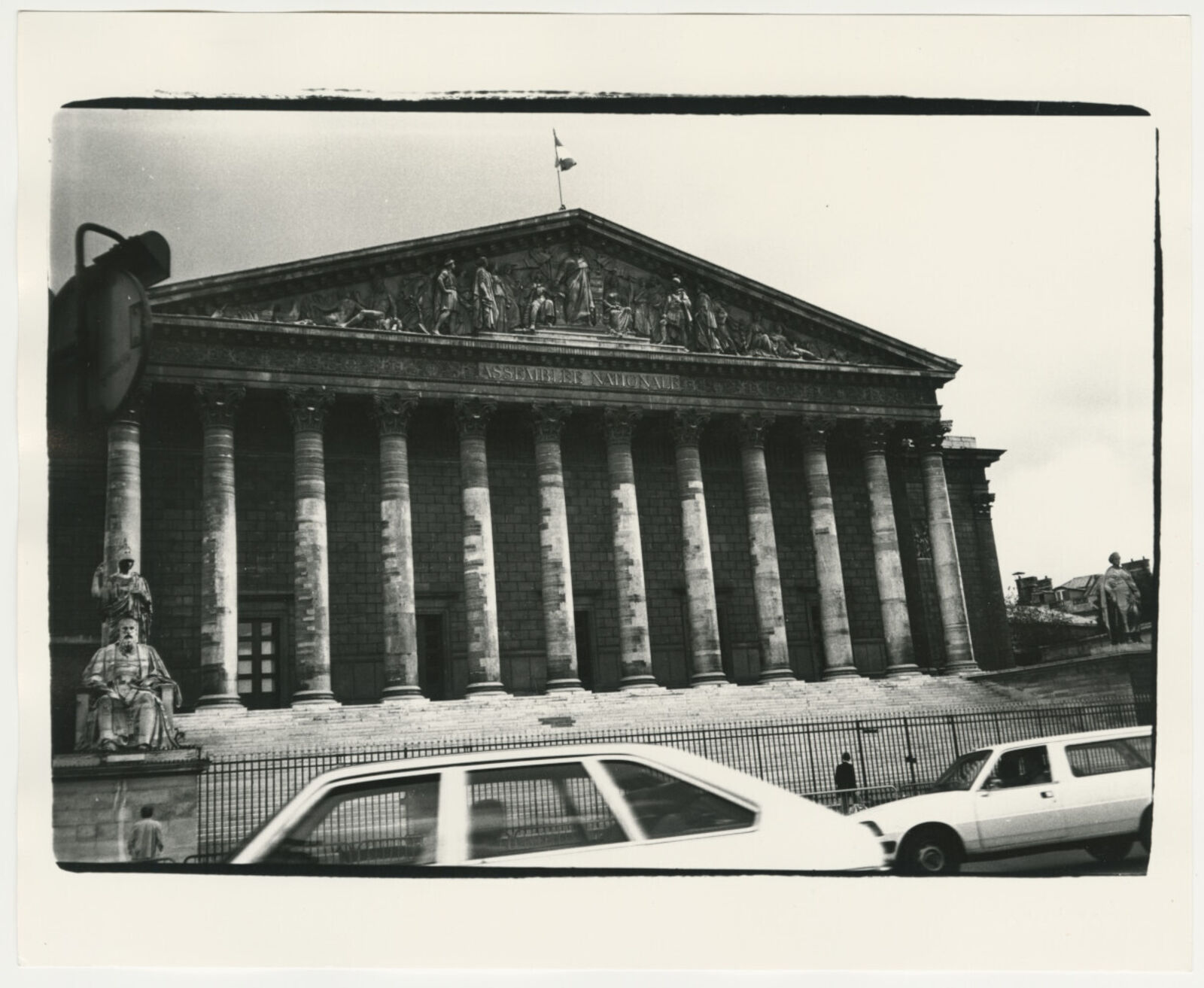 A black and white photo of a building with columns.