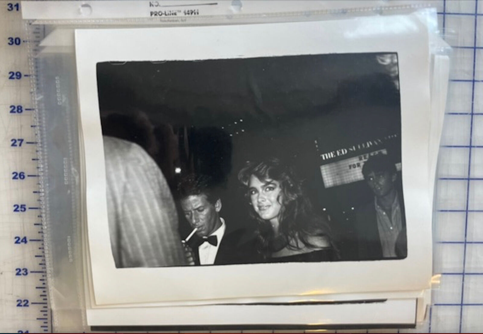 A black and white photo of a man and a woman at a party.