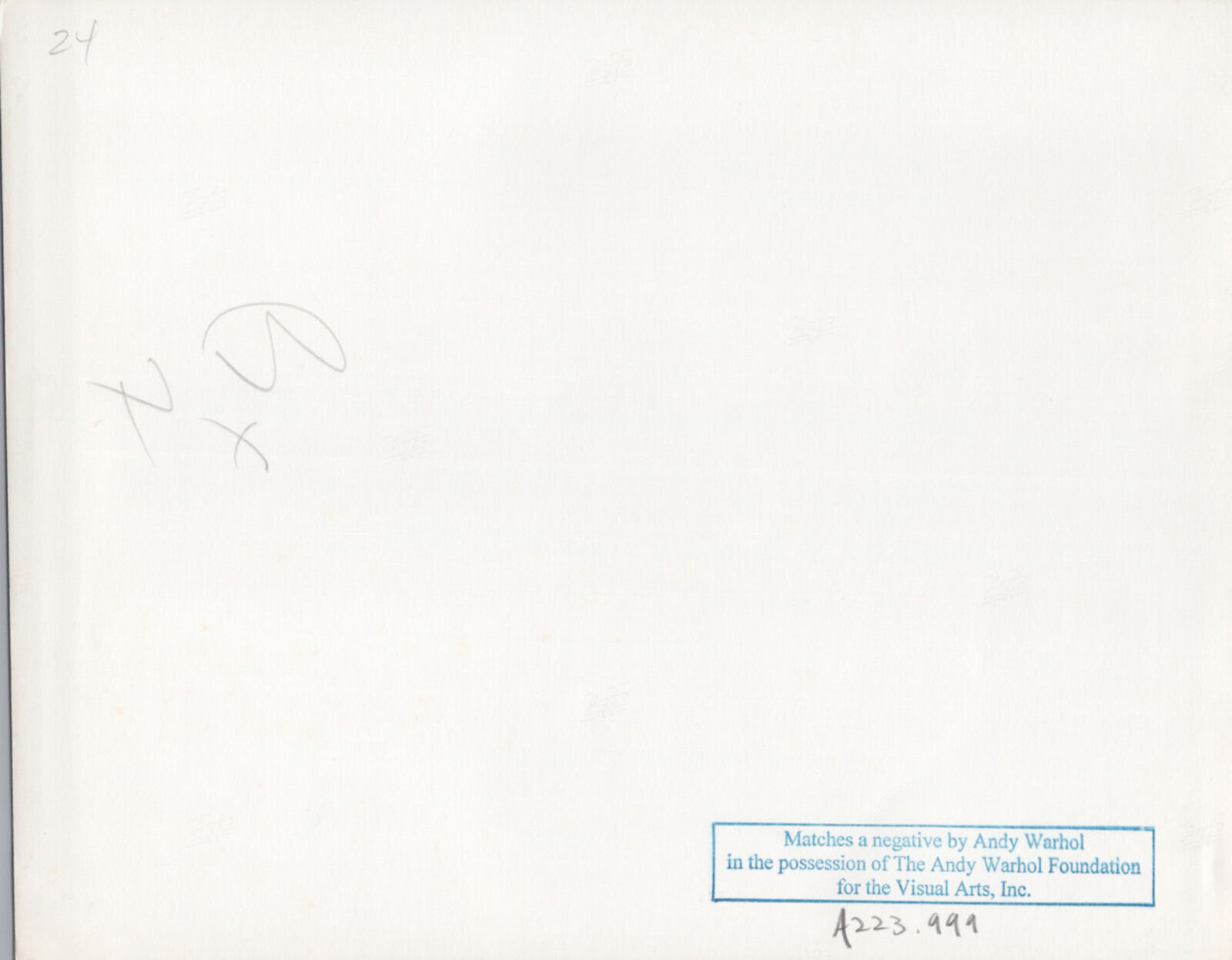 A black and white photo of a man in a tuxedo sitting at a table.