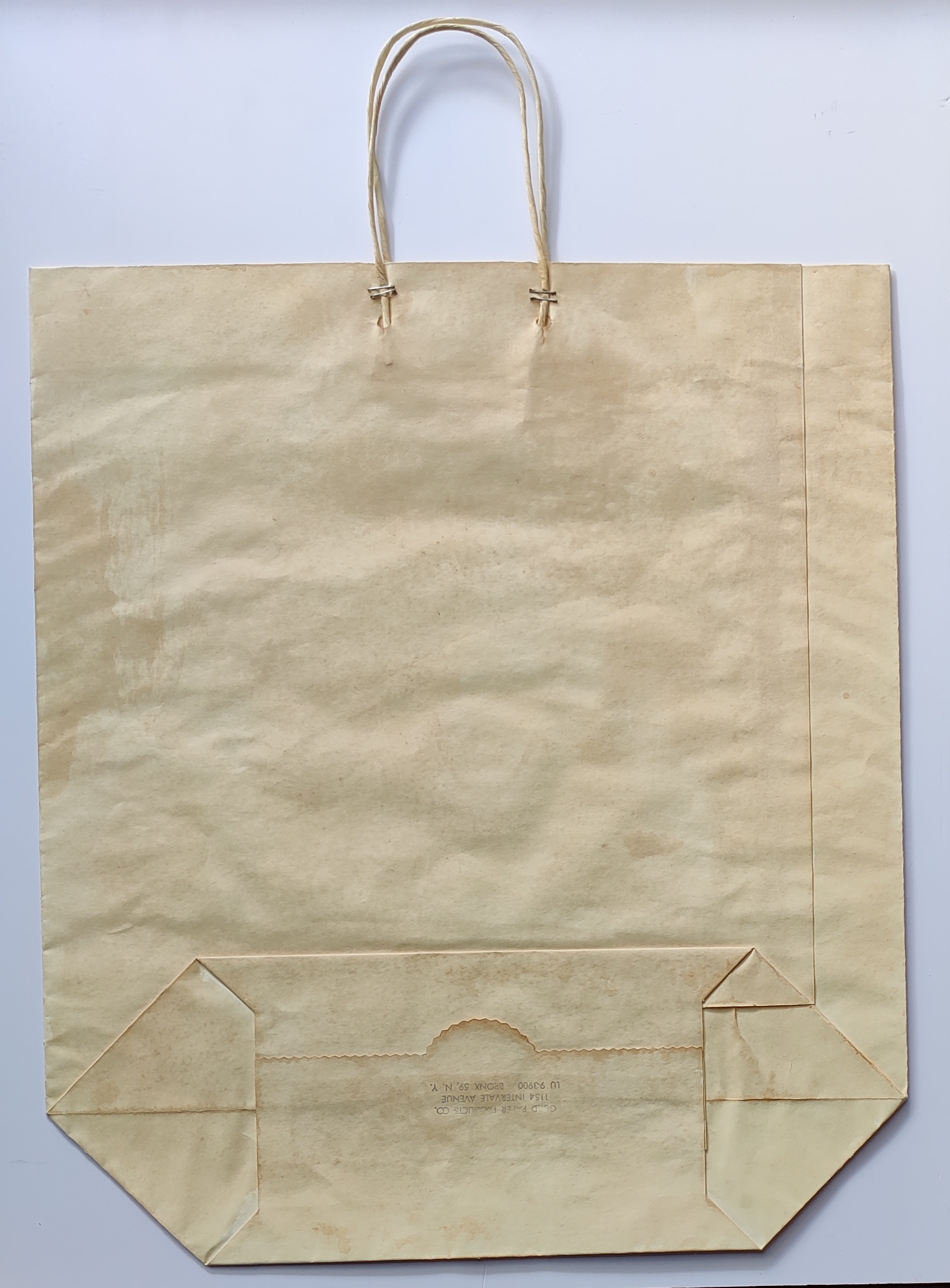 A paper bag printed with a stylized soup can design featuring bold colors and retro typography.